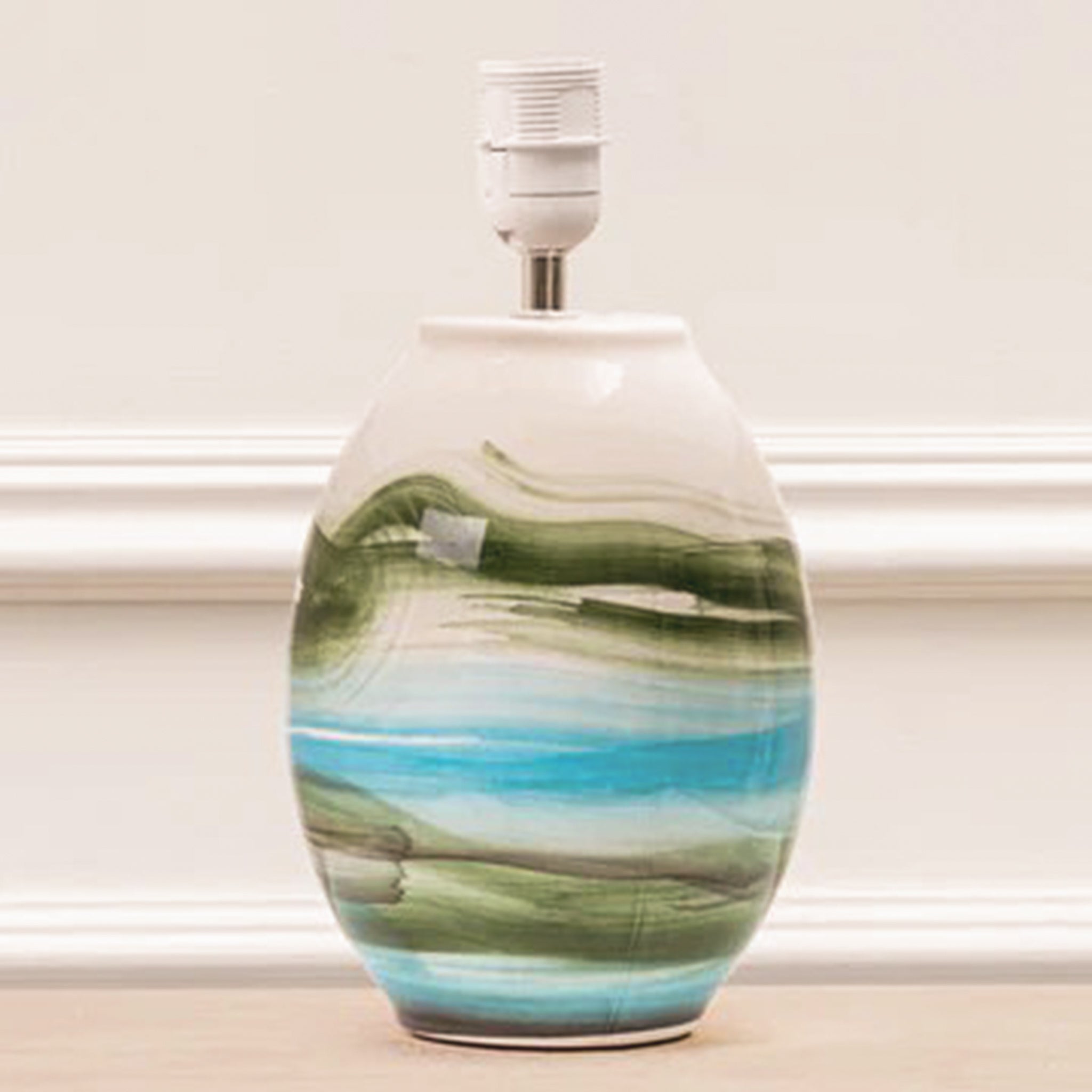 Amélie mineral ceramic table lamp base styled in a neutral interior, featuring an organic rounded form with layered green, turquoise blue, white and earthy abstract detailing.