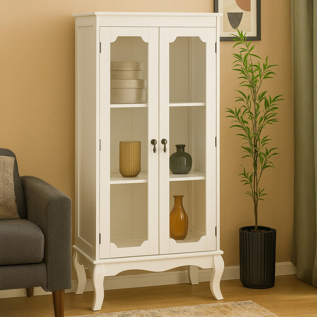 The Évangeline Ivory Display Cabinet with 2 glass doors and carved legs styled in a contemporary living room, showcasing the elegant ivory painted finish, glazed display shelves, decorative storage and classic French country furniture design.