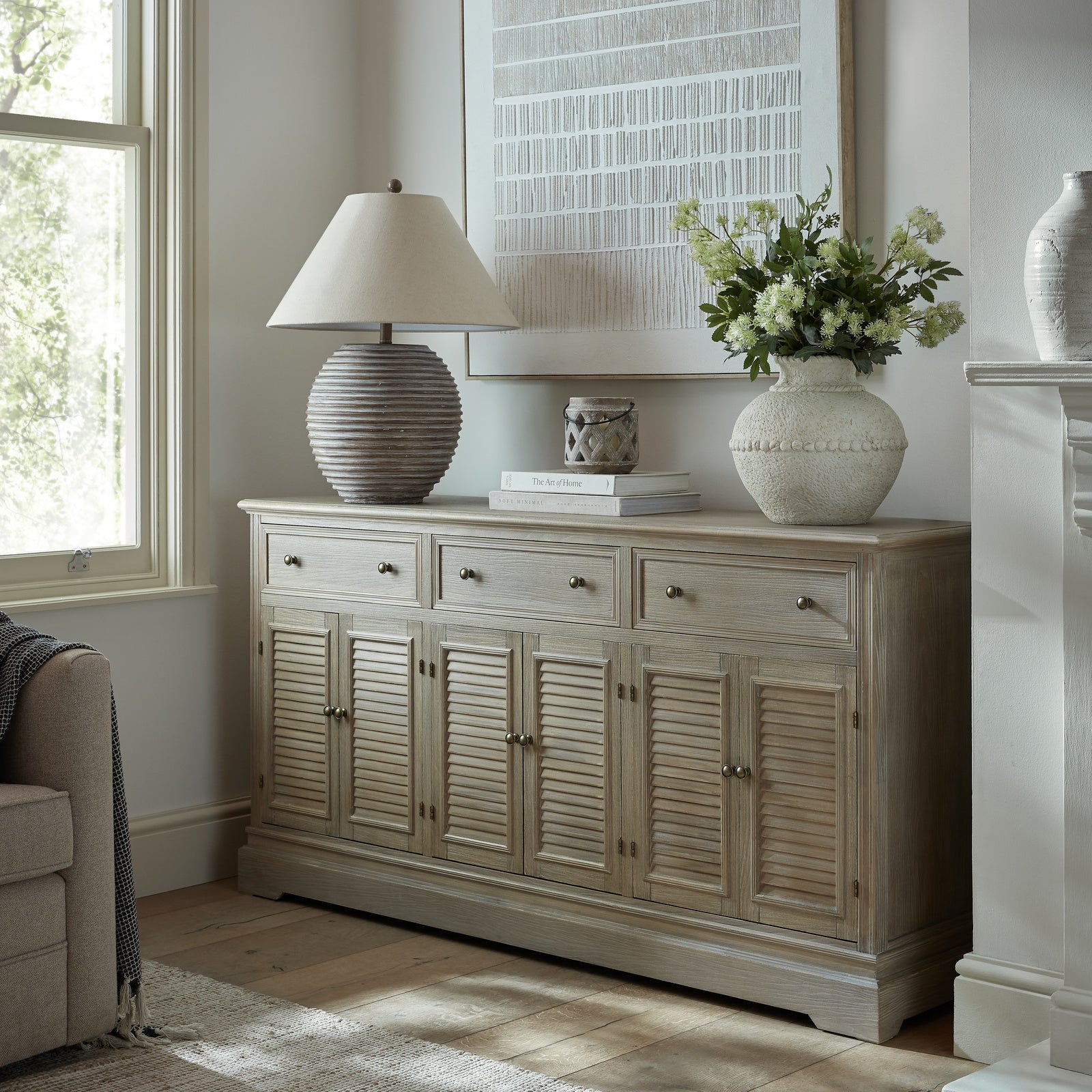 Laurent Large Wood Display Cabinet Set sideboard styled with decorative ceramics, table lamp and floral arrangement in a bright living room, showcasing generous wooden storage drawers, cupboard space and classic open display shelving.