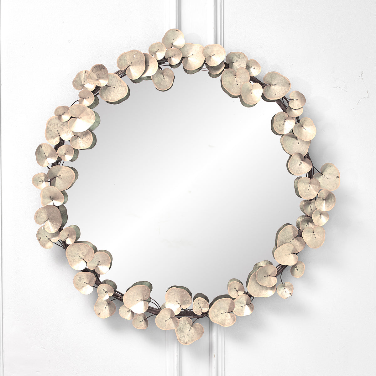 Front view of the Odette 109cm Round Wall Mirror featuring an antique white and gold floral metal frame with layered decorative leaf detailing, creating a luxury statement wall mirror for contemporary, classic and farmhouse interiors.