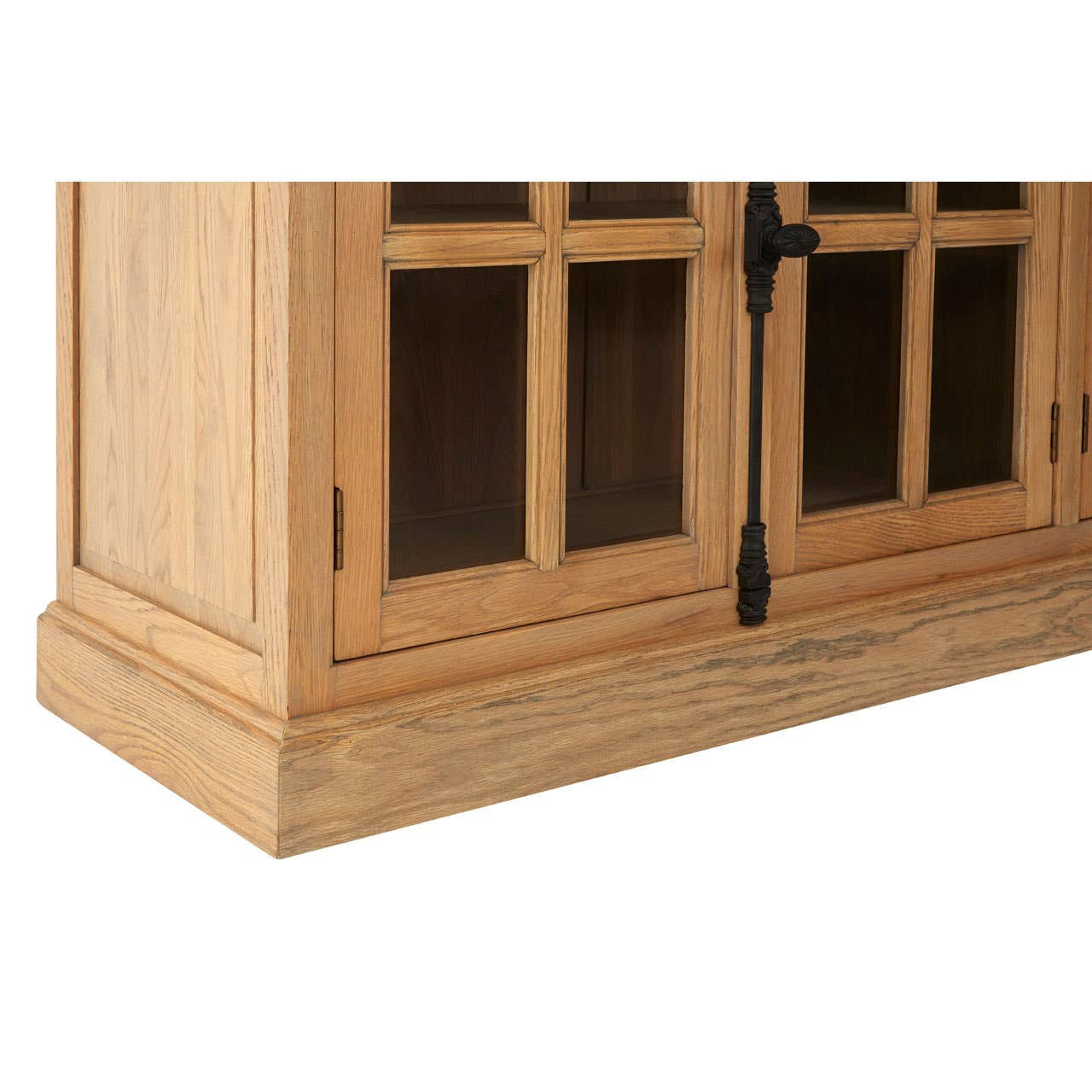 Detailed corner view of the Alaric Four Door Display Sideboard showing the washed oak wood frame, glazed cabinet doors, black metal hardware, solid plinth base and handcrafted construction.