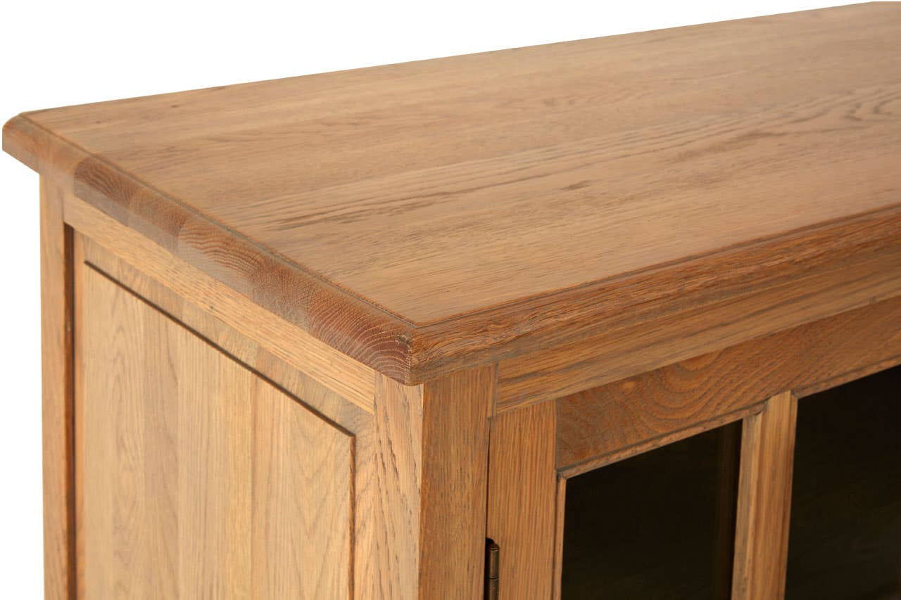 Close-up of the Alaric Four Door Display Sideboard highlighting the washed oak wood grain, solid top surface, handcrafted joinery and natural oak finish with beautifully defined timber detailing.