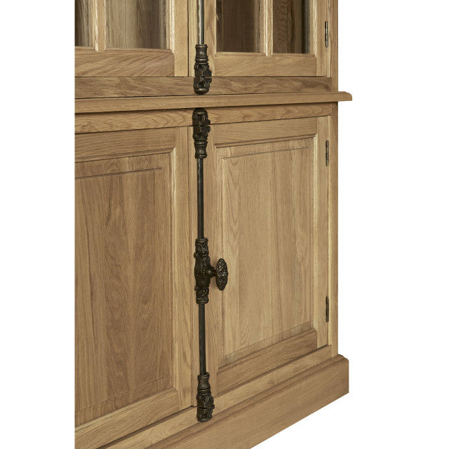 Close-up of the Alaric Tall Oak Wood Display Cabinet highlighting the decorative antique-style iron door espagnolette handle, framed solid oak cupboard doors and premium handcrafted detailing.