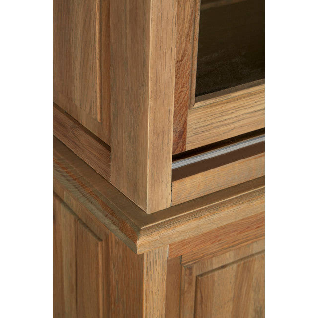 Close-up of the Alaric Tall Oak Wood Display Cabinet highlighting the solid oak frame, natural wood grain, moulded trim and premium craftsmanship around the sliding glass display section.