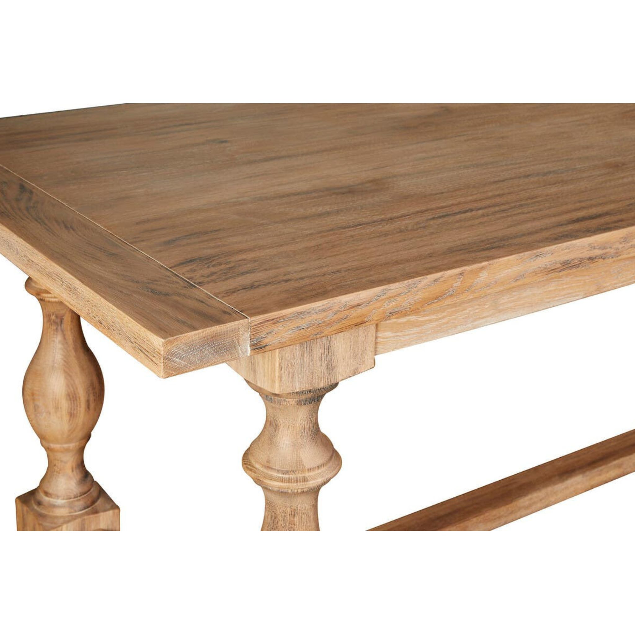 Close-up of Alaric washed oak dining table top, wood grain and turned legs on a clean white studio background.