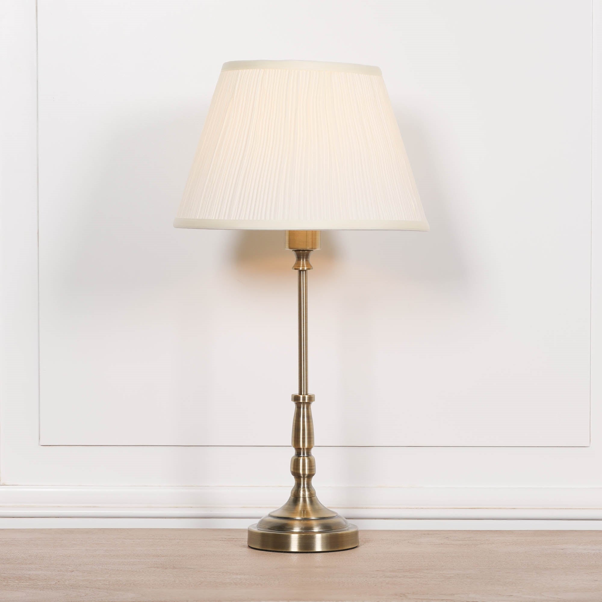 Full-height view of the Amélie Classical satin brass candlestick table lamp with cream pleated shade, elegant traditional lighting for bedside tables, console tables and home offices.
