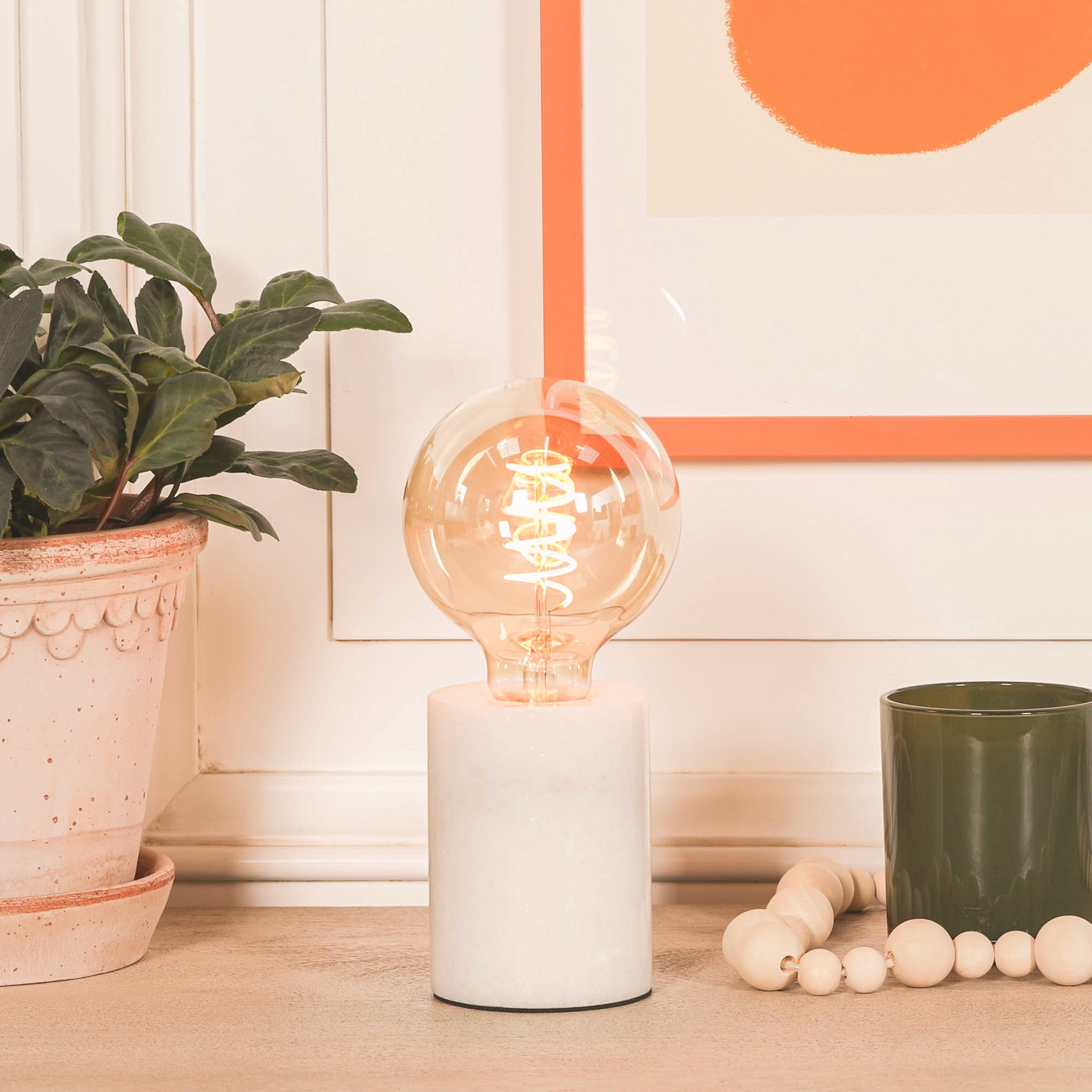 Amélie Industrial White Marble Table Lamp with Braided Cord displayed on a console table with decorative accessories, highlighting contemporary industrial lighting and luxury marble craftsmanship for modern interiors.