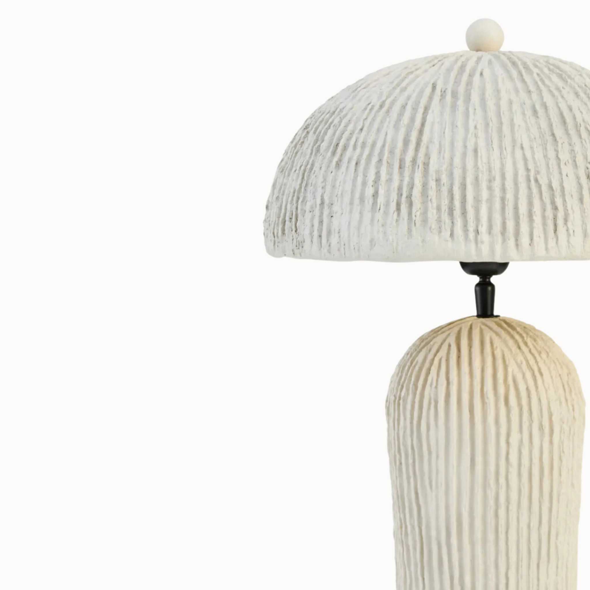 Close-up of Amélie papier mâché table lamp with ribbed domed shade on a plain white background.