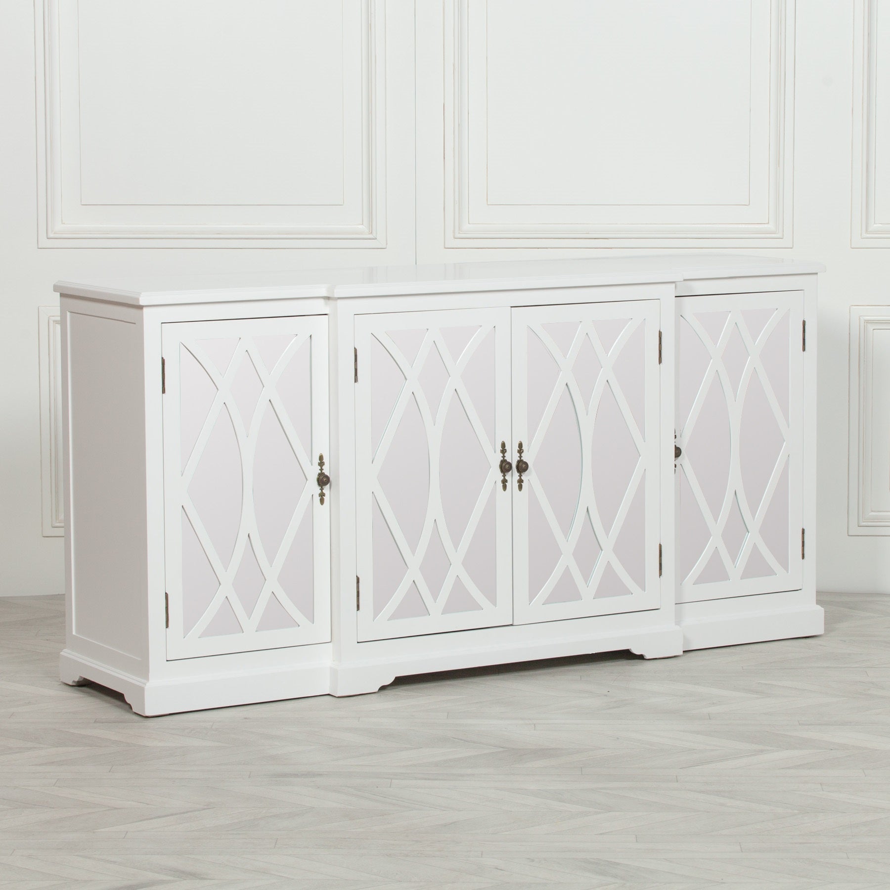 Angled view of the Anaïs White Mirrored Four Door Breakfront Sideboard featuring mirrored lattice glass doors, crisp white painted finish, breakfront design and generous storage for elegant living room or dining room interiors.