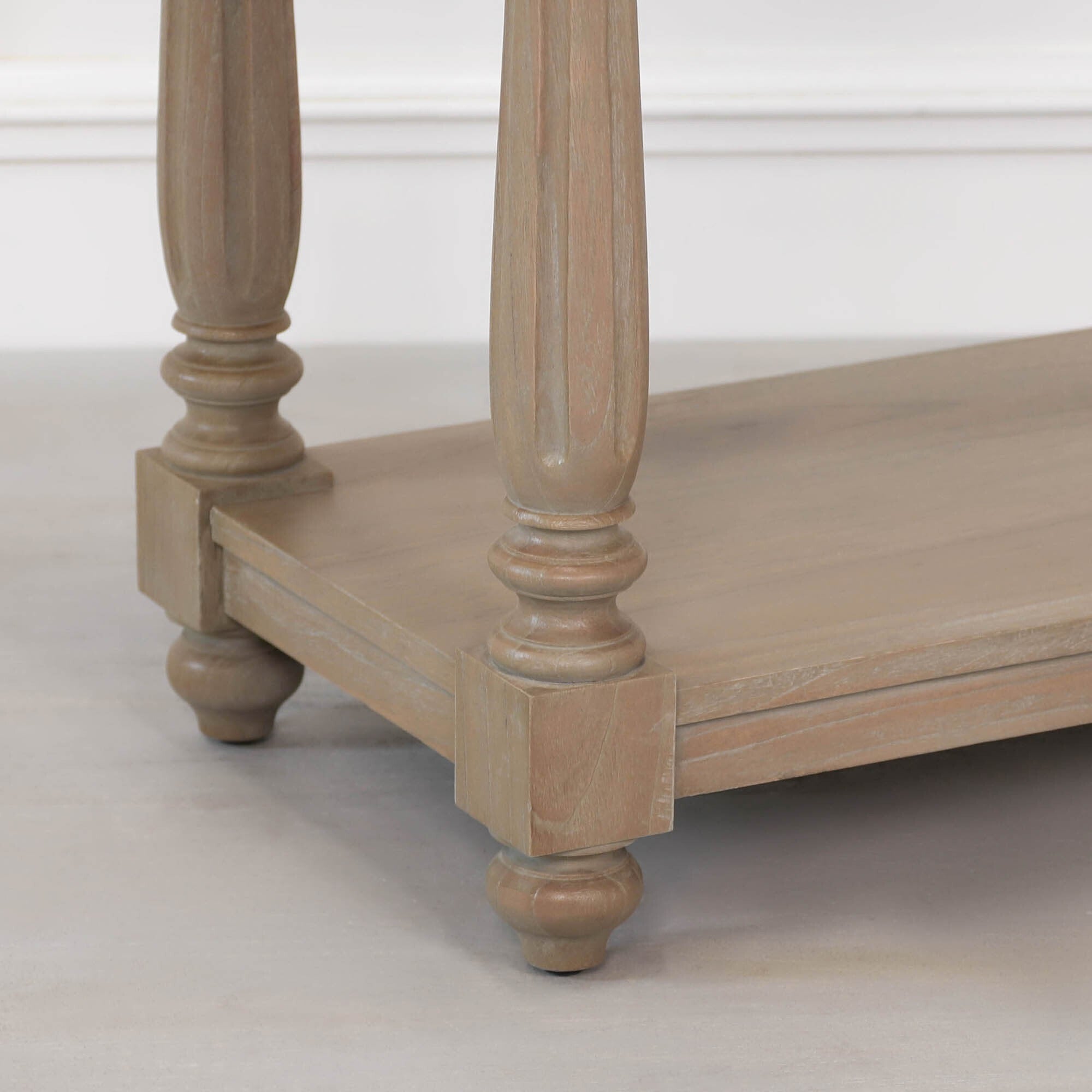 Armand cedar wood console table close-up showing lower shelf, turned legs and rounded wooden feet