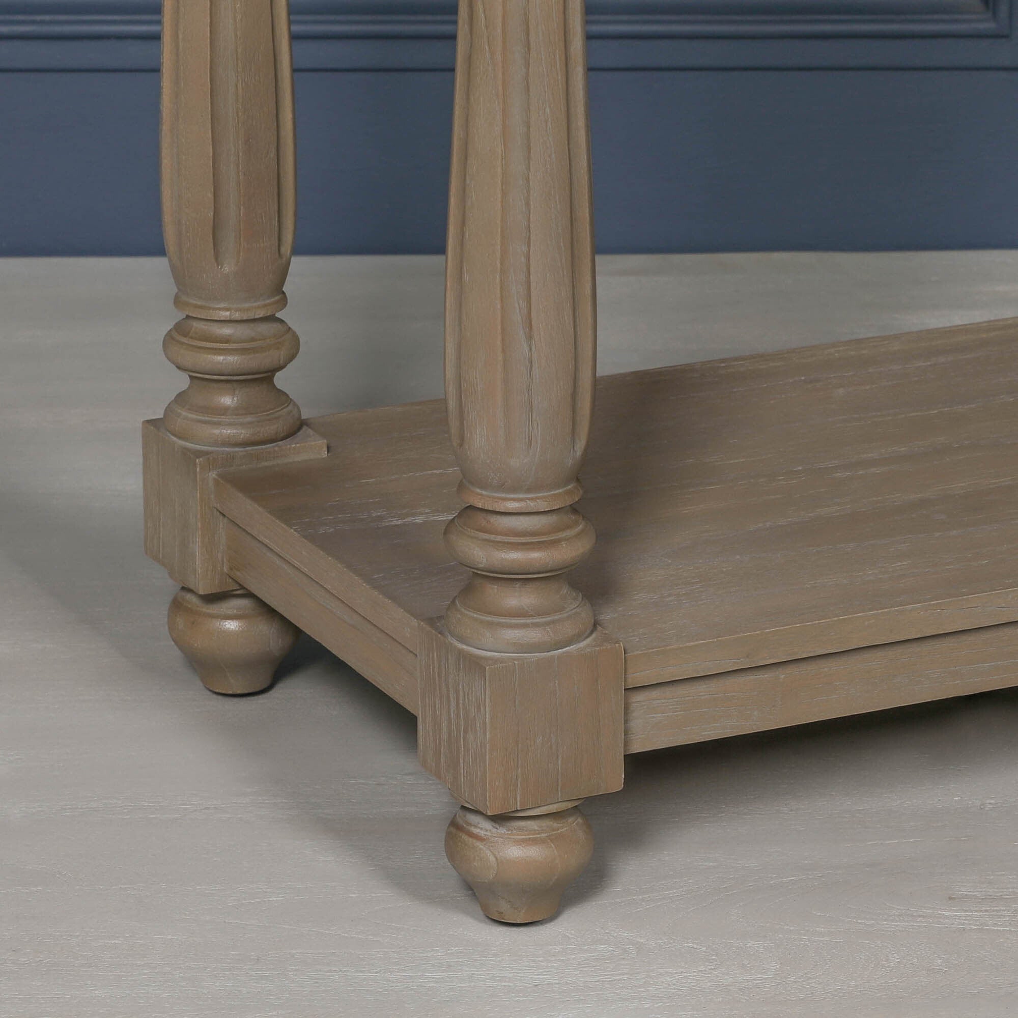 Close-up of Armand cedar wood console table showing turned legs, rounded feet and spacious lower shelf