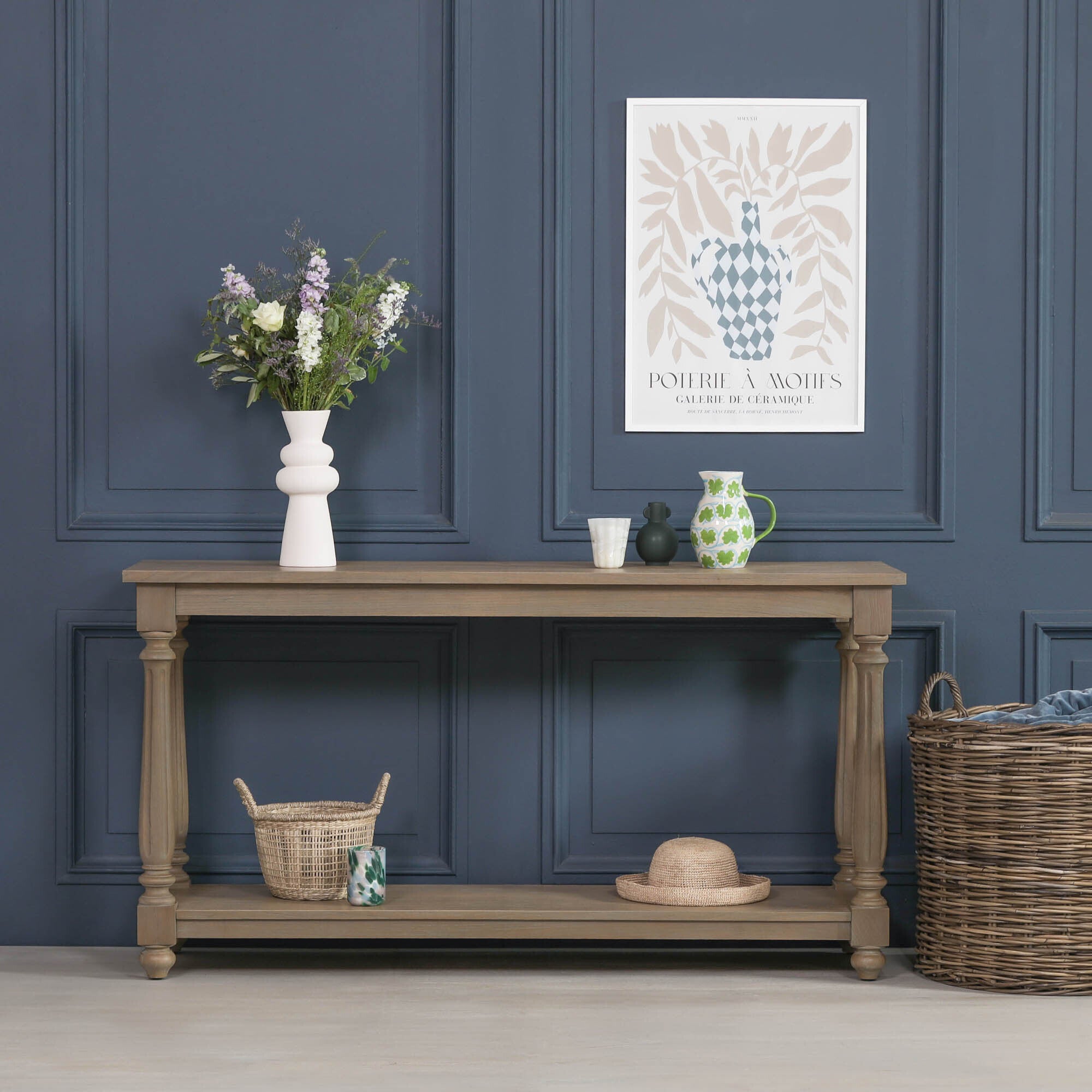 Armand large white cedar console table with lower shelf styled with flowers and decorative accessories