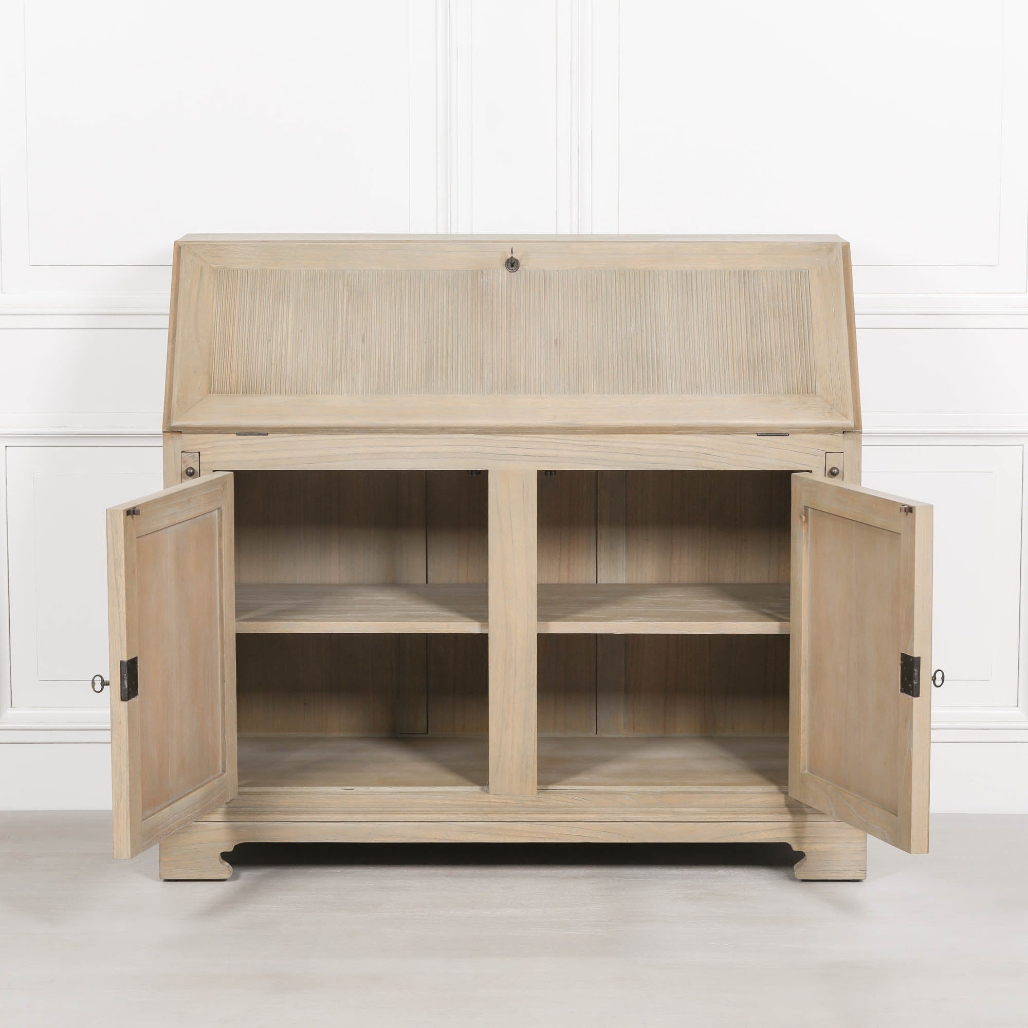 Armand white cedar bureau desk with lower storage doors open, showing internal shelves against a white wall.