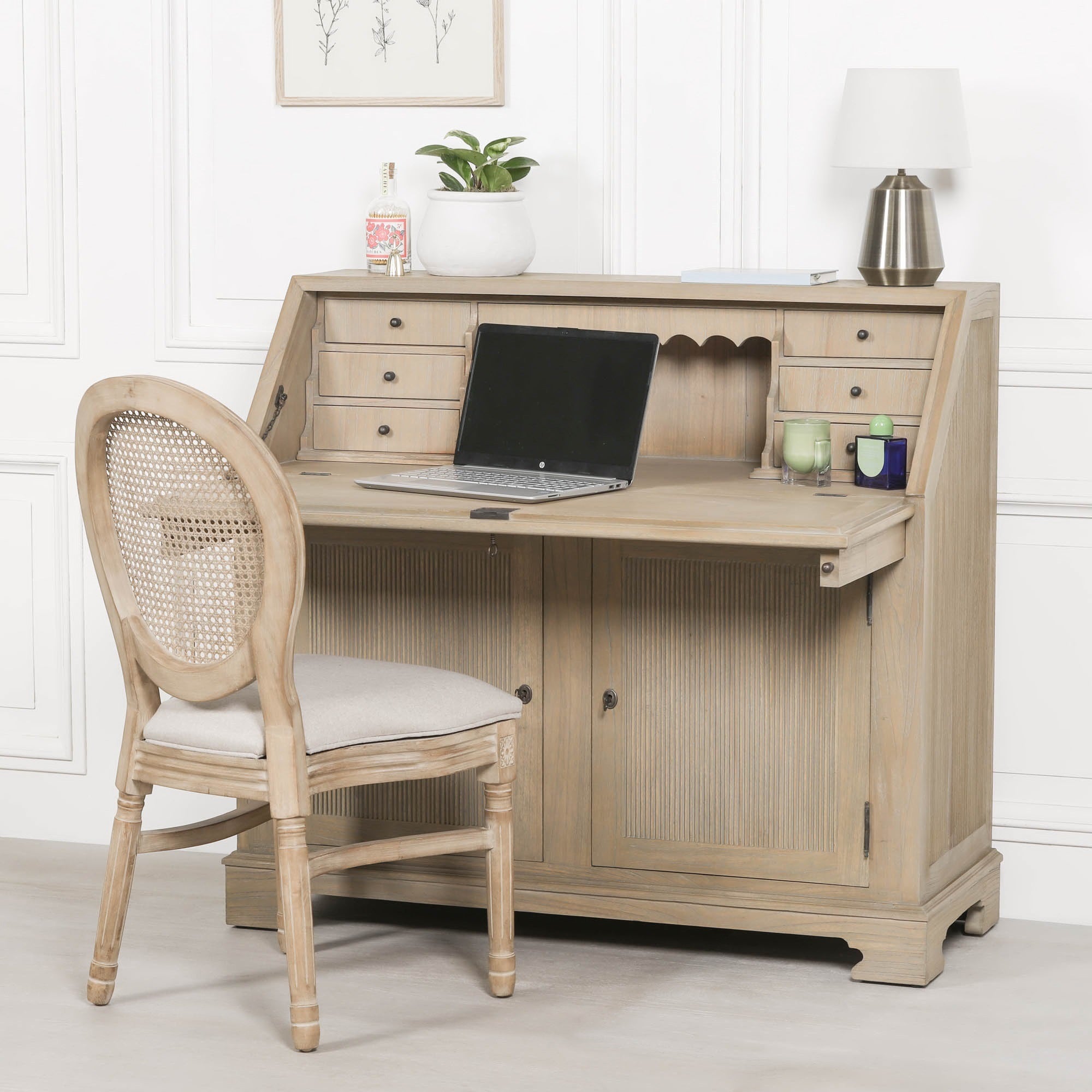Armand white cedar bureau writing desk with chair, open desktop, drawers and storage against a white panelled wall.
