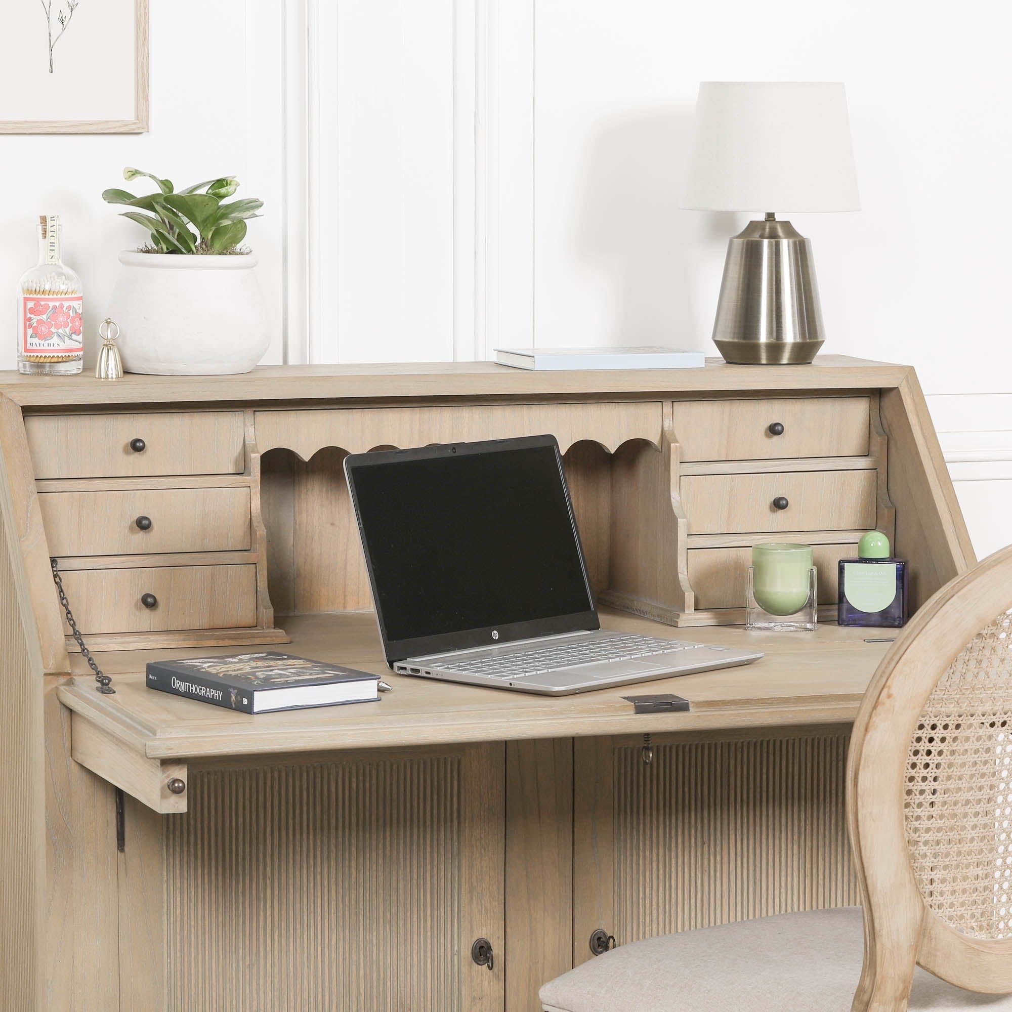 Armand white cedar bureau writing desk open with laptop, drawers and storage against a bright white panelled wall.