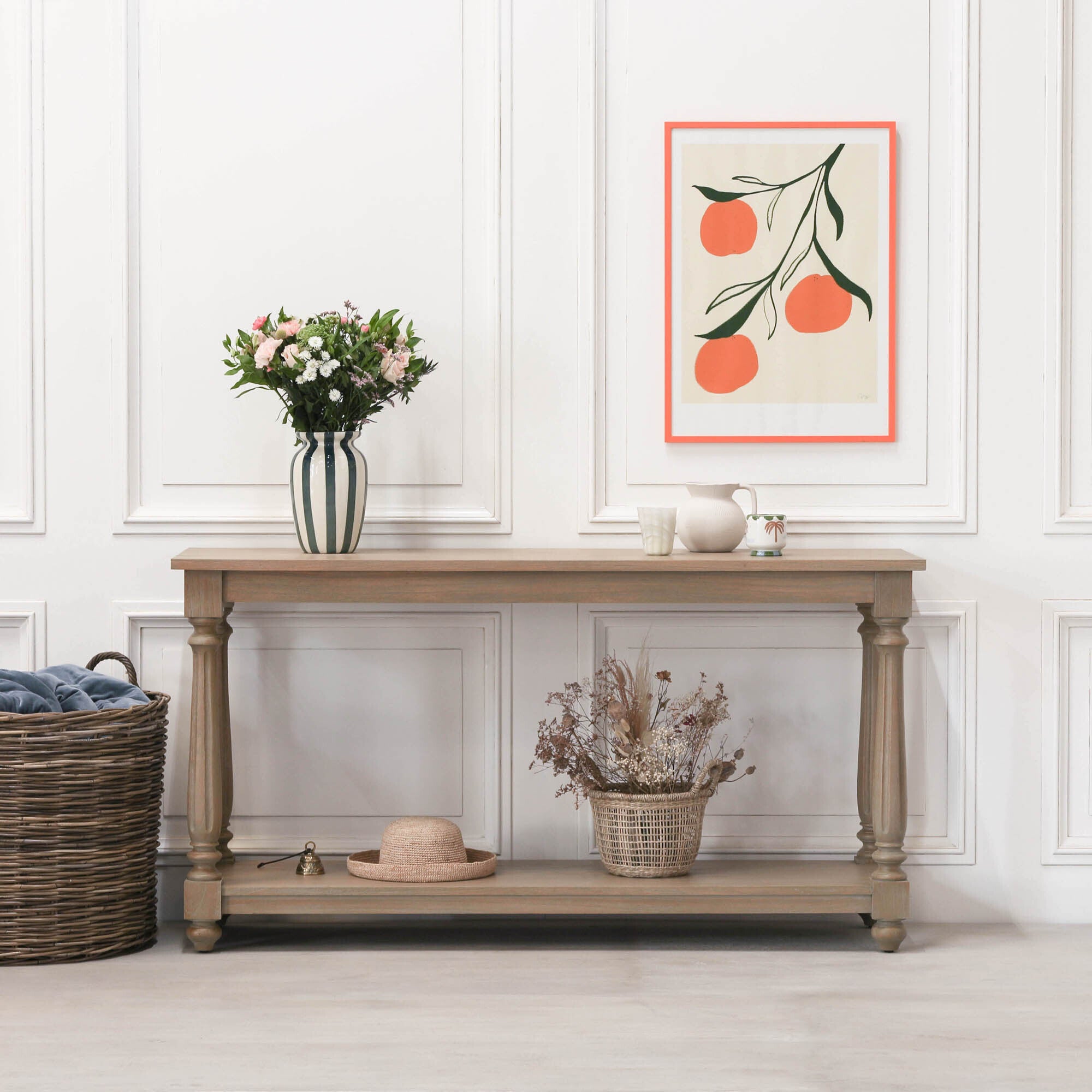 Armand white cedar console table with lower shelf styled with flowers and decor in a bright hallway interior