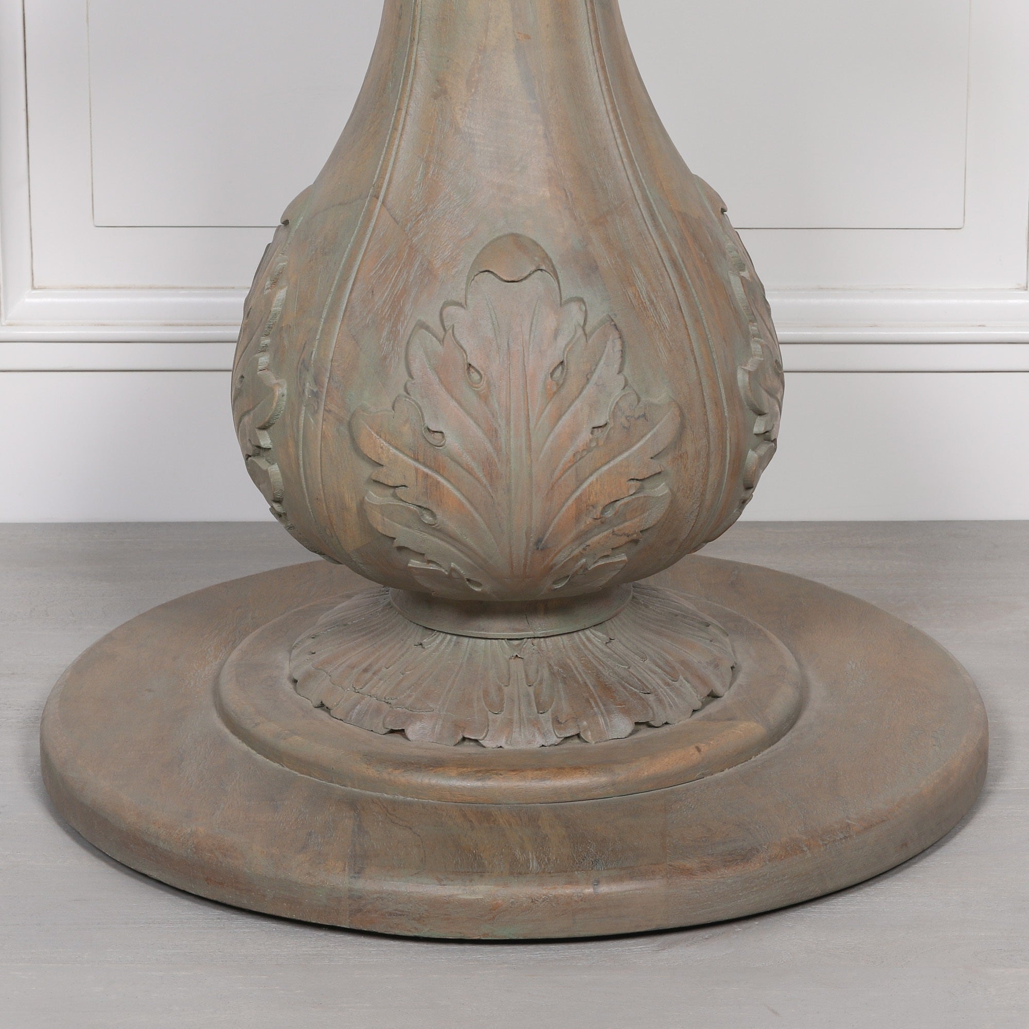 Close-up of the carved acorn pedestal base on the Auguste Round Acorn Pedestal Dining Table 150cm for 6, highlighting intricate leaf carvings, handcrafted Rustic Washed Hardwood construction and traditional artisan craftsmanship.