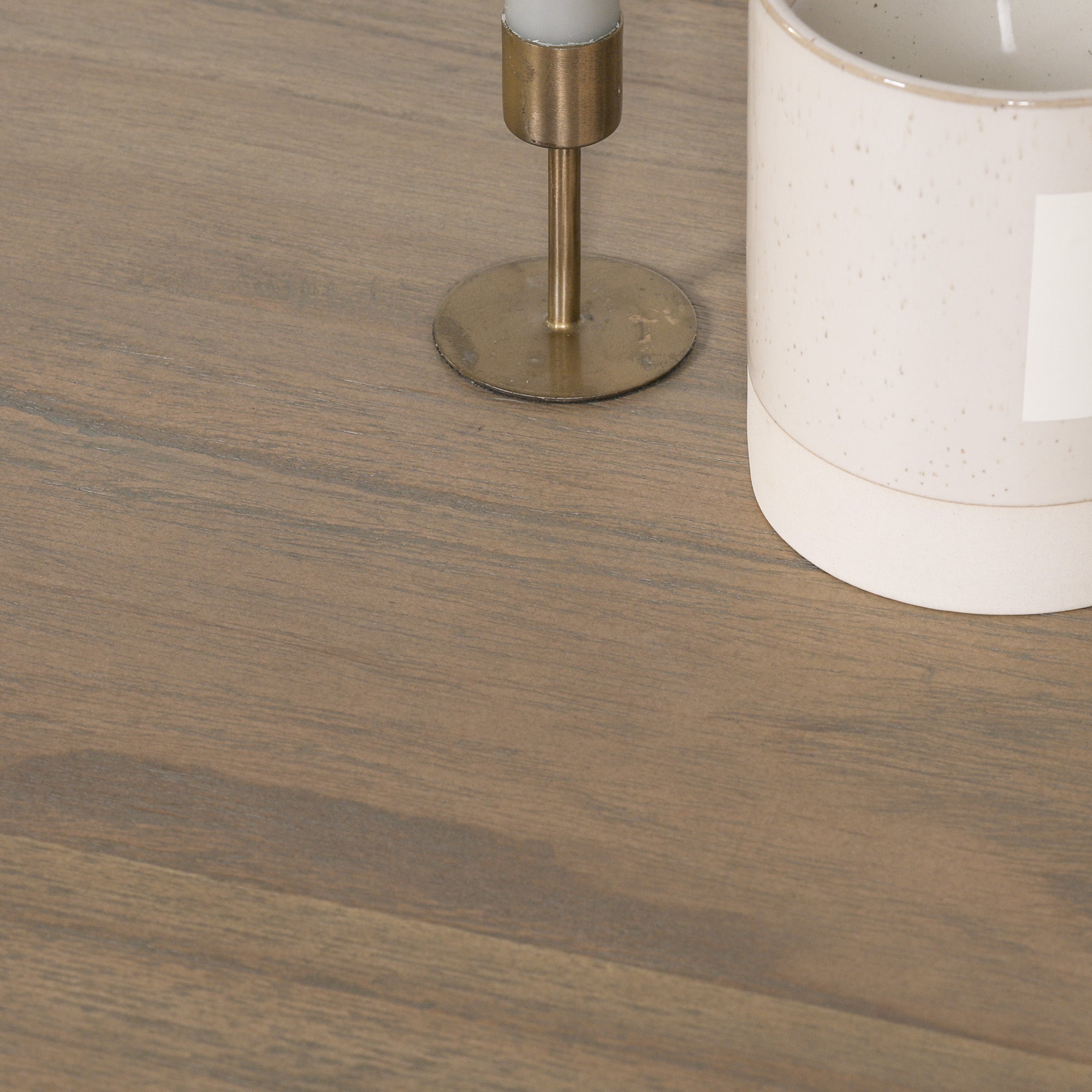 Detailed close-up of the Auguste Round Acorn Pedestal Dining Table tabletop showcasing the natural Rustic Washed Hardwood grain, smooth handcrafted finish, thick solid wood edge and premium round dining table construction.