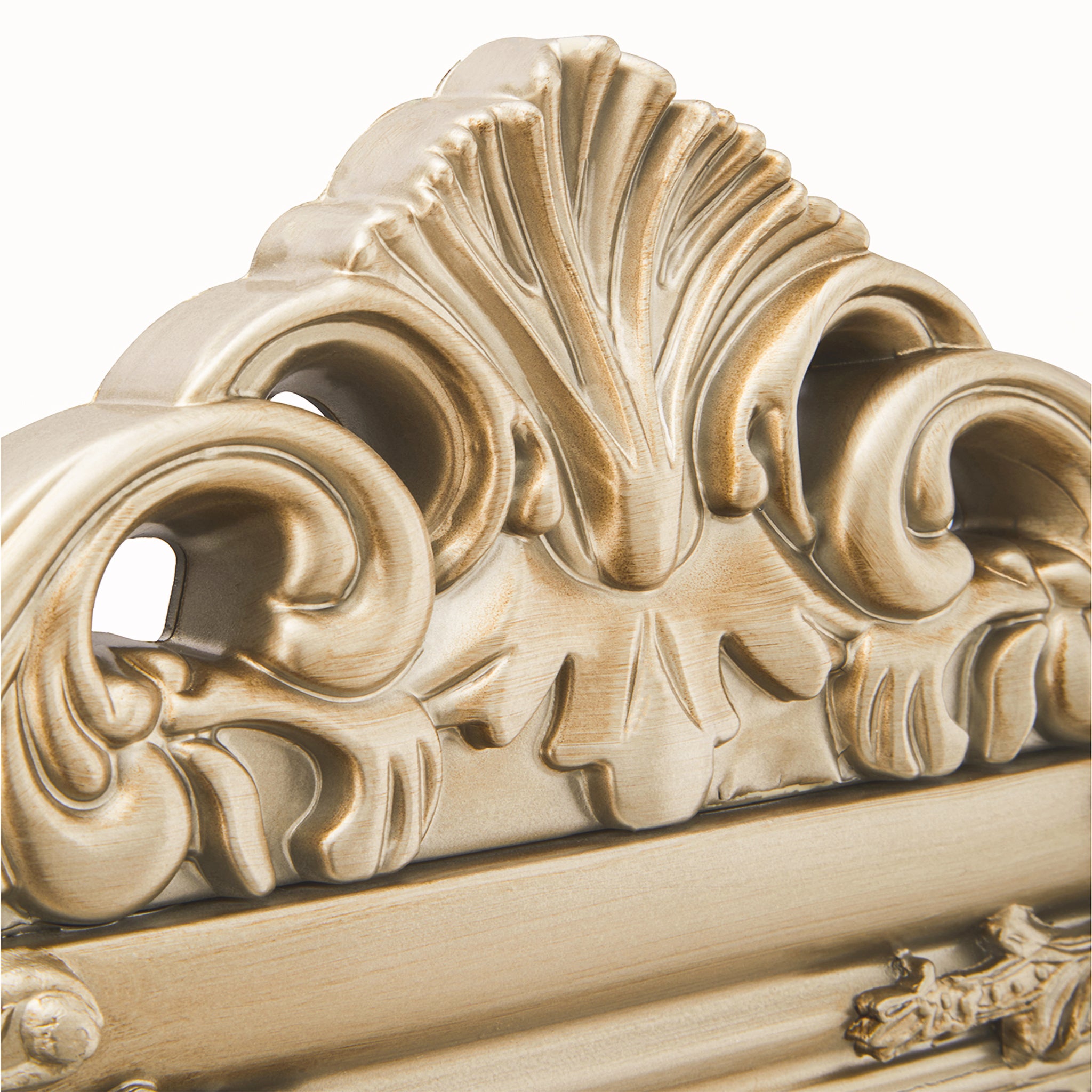 Close-up of the Aurelia champagne gilded floor mirror's ornate upper crest, highlighting sculptural scrollwork, shell-inspired detailing and an antique-style champagne gold finish.