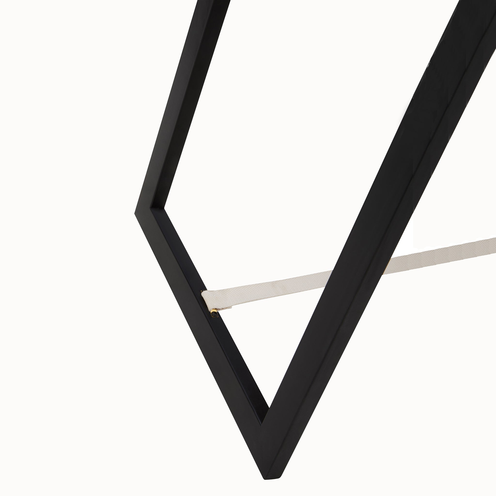 Close-up of the Aurelia freestanding floor mirror's black easel-style rear stand and support strap, showing the practical support structure behind the tall full-length dressing mirror.