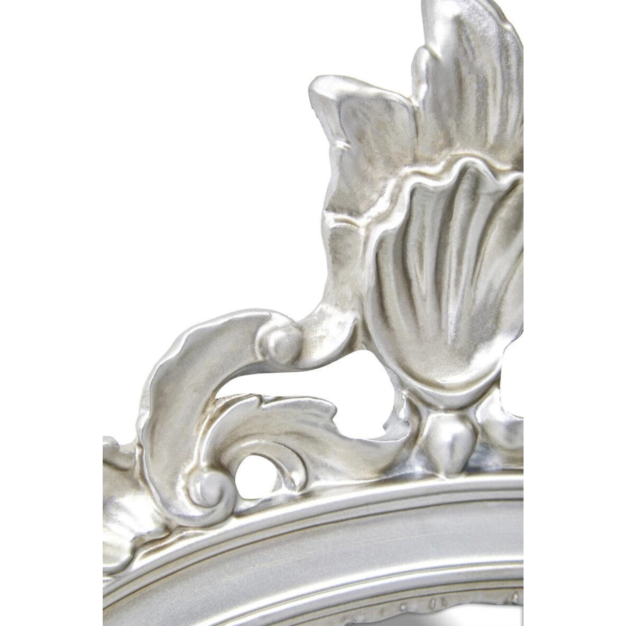 Close-up of Aurelia silver wall mirror showing the sculpted floral crest and ornate metallic frame on white.