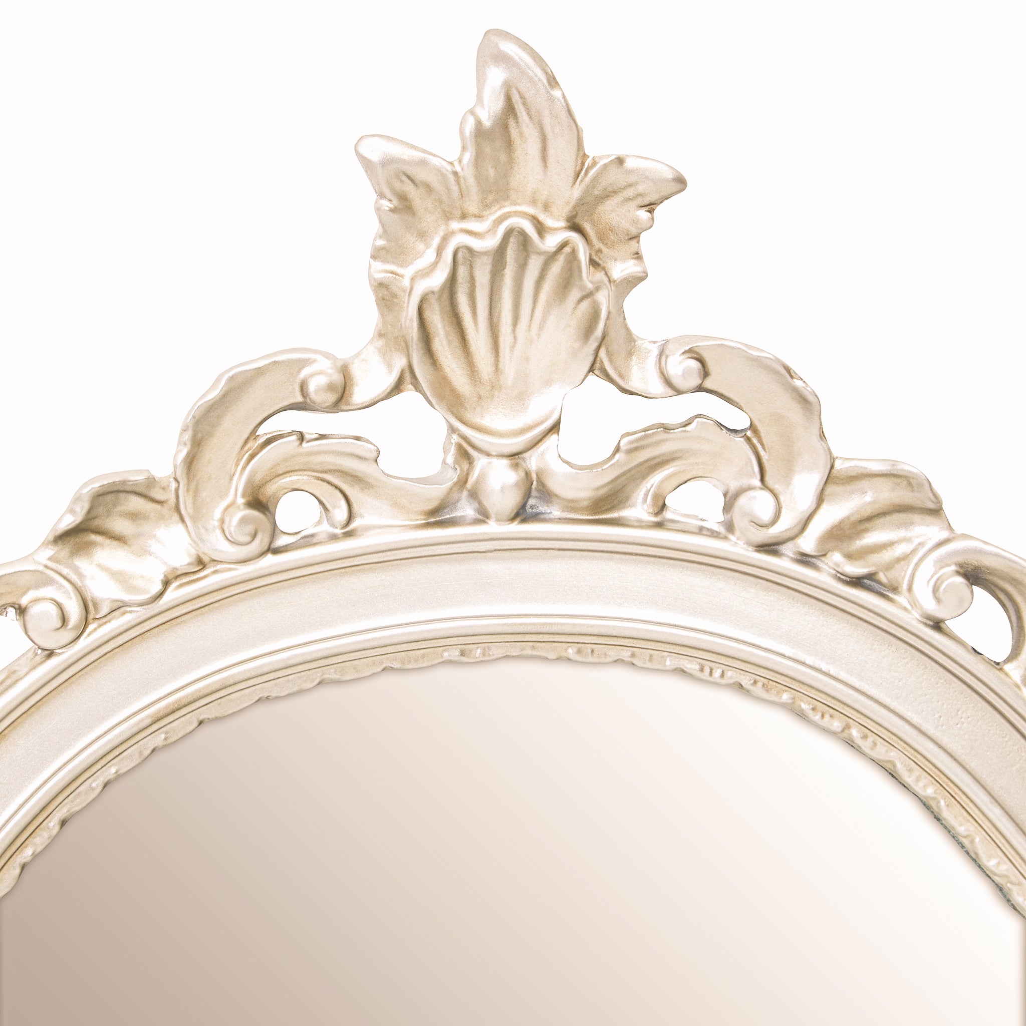 Detailed view of the arched top of the Aurelia wall mirror featuring an elegant silver frame finish with decorative crest, carved flourishes and classic French-style ornamental detailing.