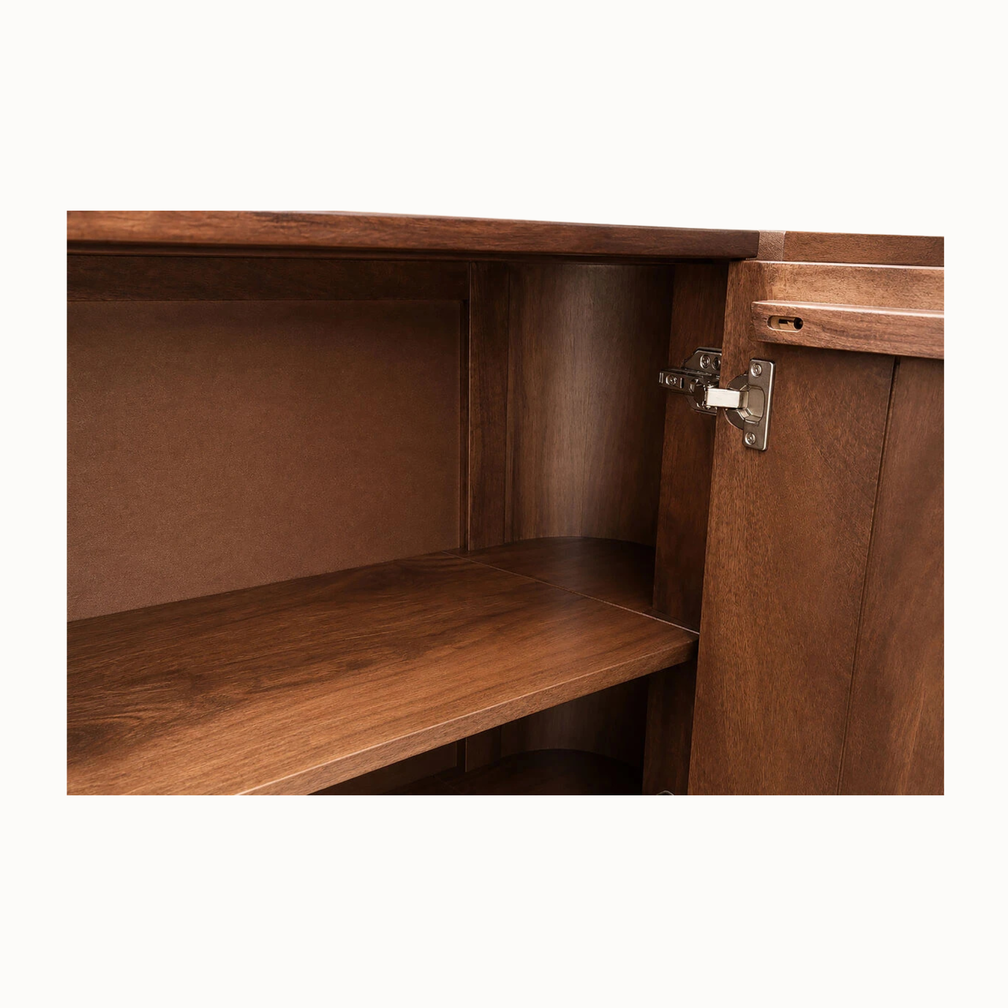 Close-up of mango wood sideboard interior showing storage shelf, door and metal hinge against a white background.
