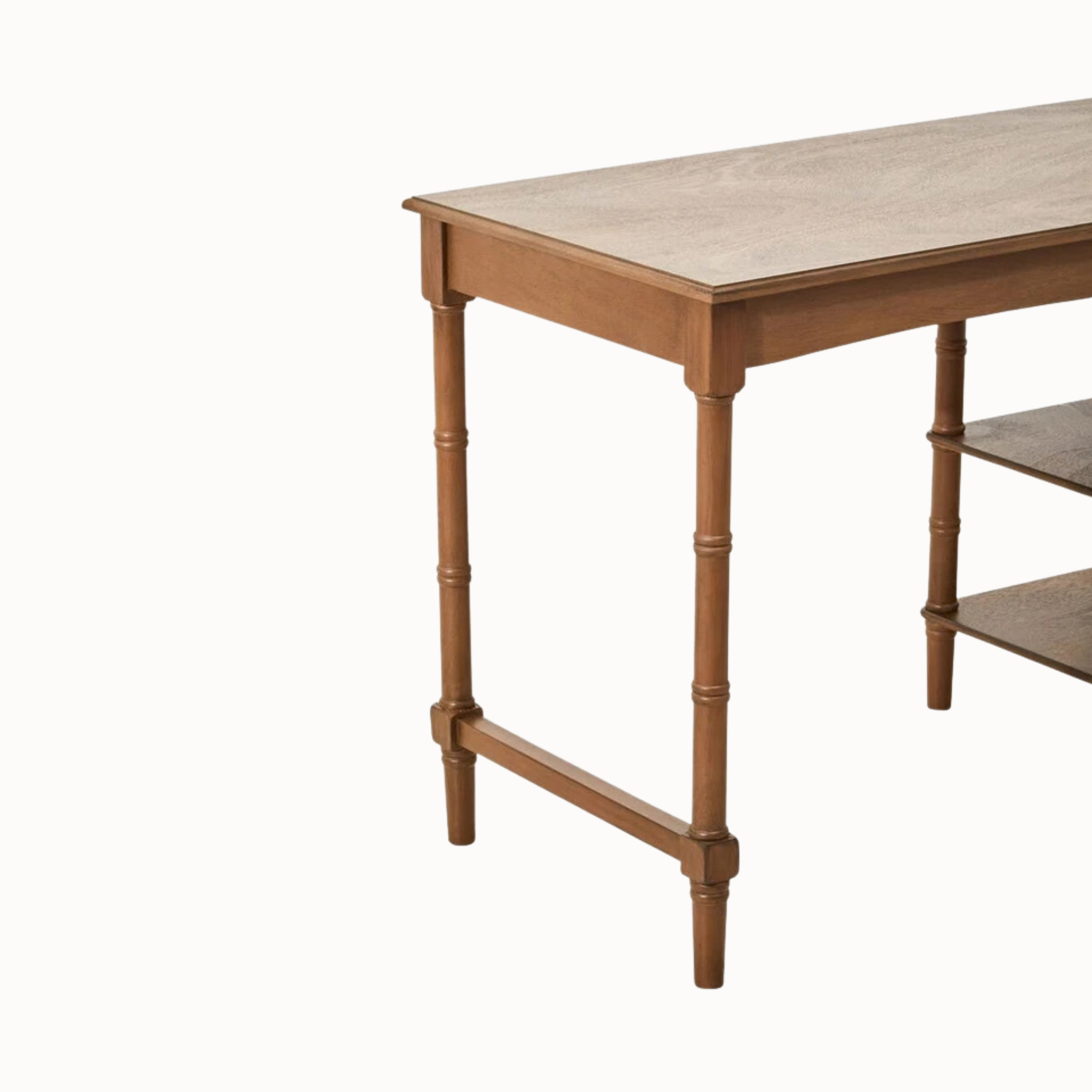 Front view of Aveline 116cm brown wood writing desk with single drawer, two open shelves and turned legs on white.