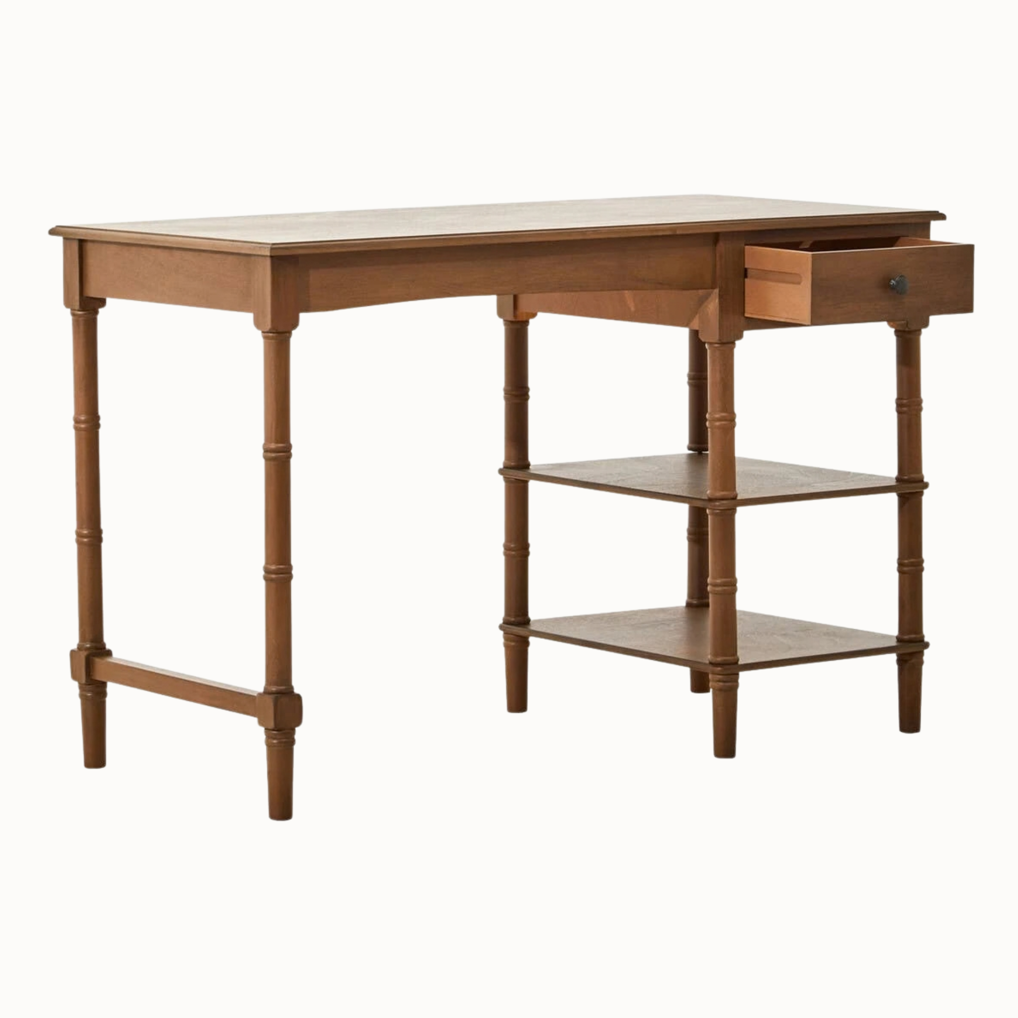 Aveline brown wood writing desk side view, showing two open storage shelves and bamboo-style turned legs on white.