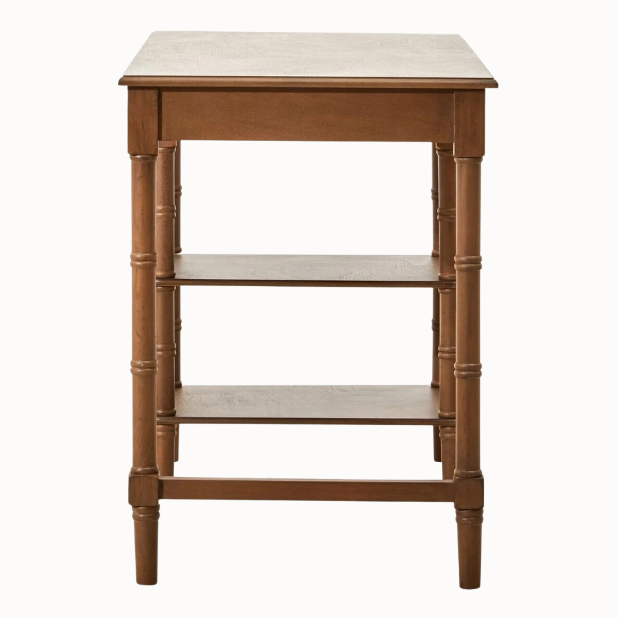 Side detail of Aveline brown wood writing desk with single drawer, dark round knob and two open shelves on white.