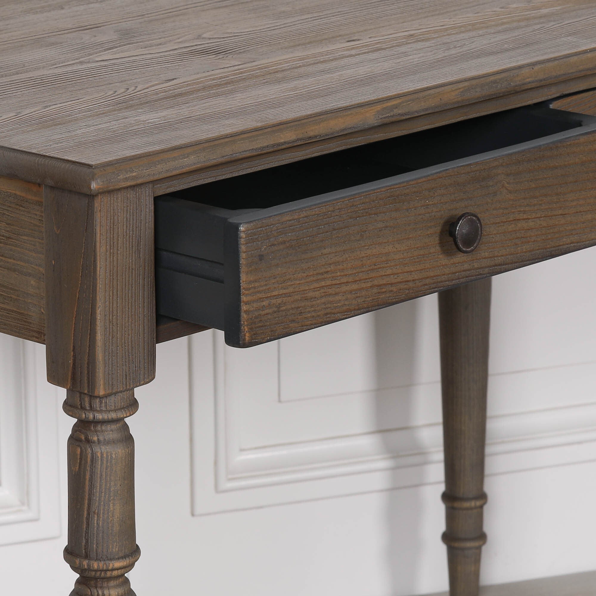 Aveline pine wood writing desk open drawer and dark round knob detail against a white panelled wall