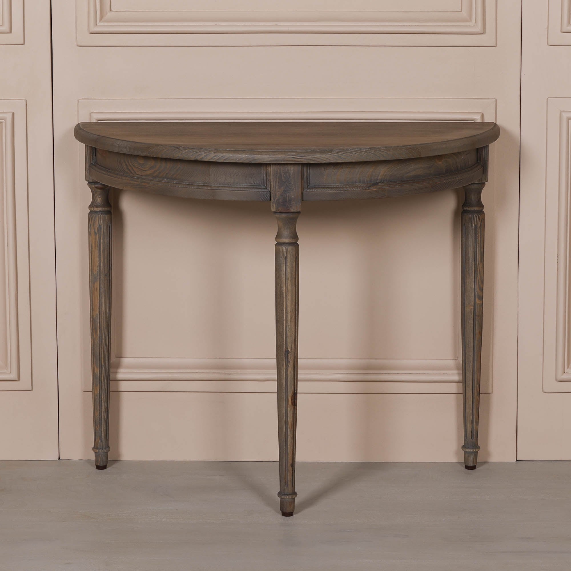 Front view of Aveline rustic pine demi-lune console table with semi-circular top, curved apron and turned wooden legs.