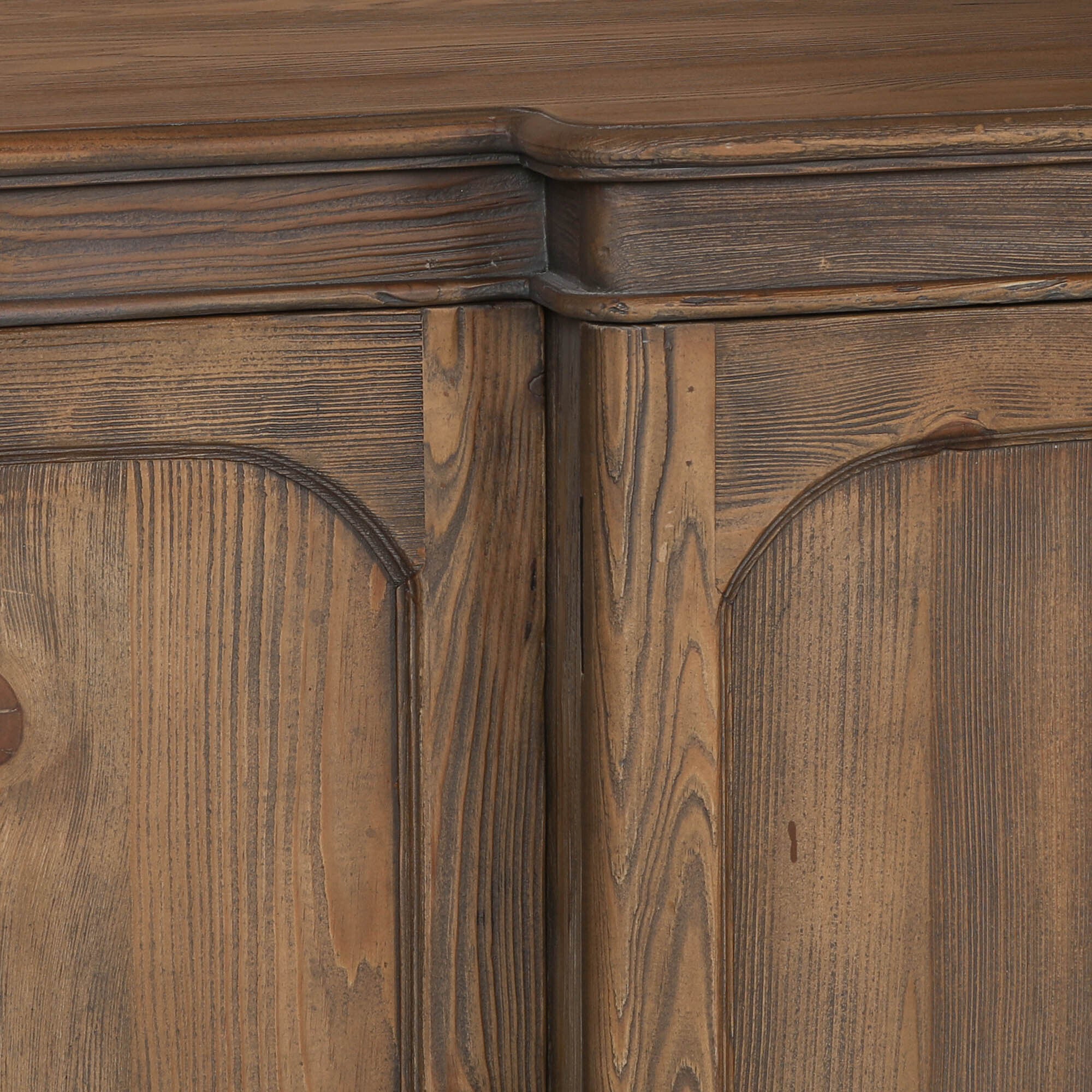 Close-up of Aveline rustic pine sideboard showing weathered wood grain, arched door detailing and moulded top.