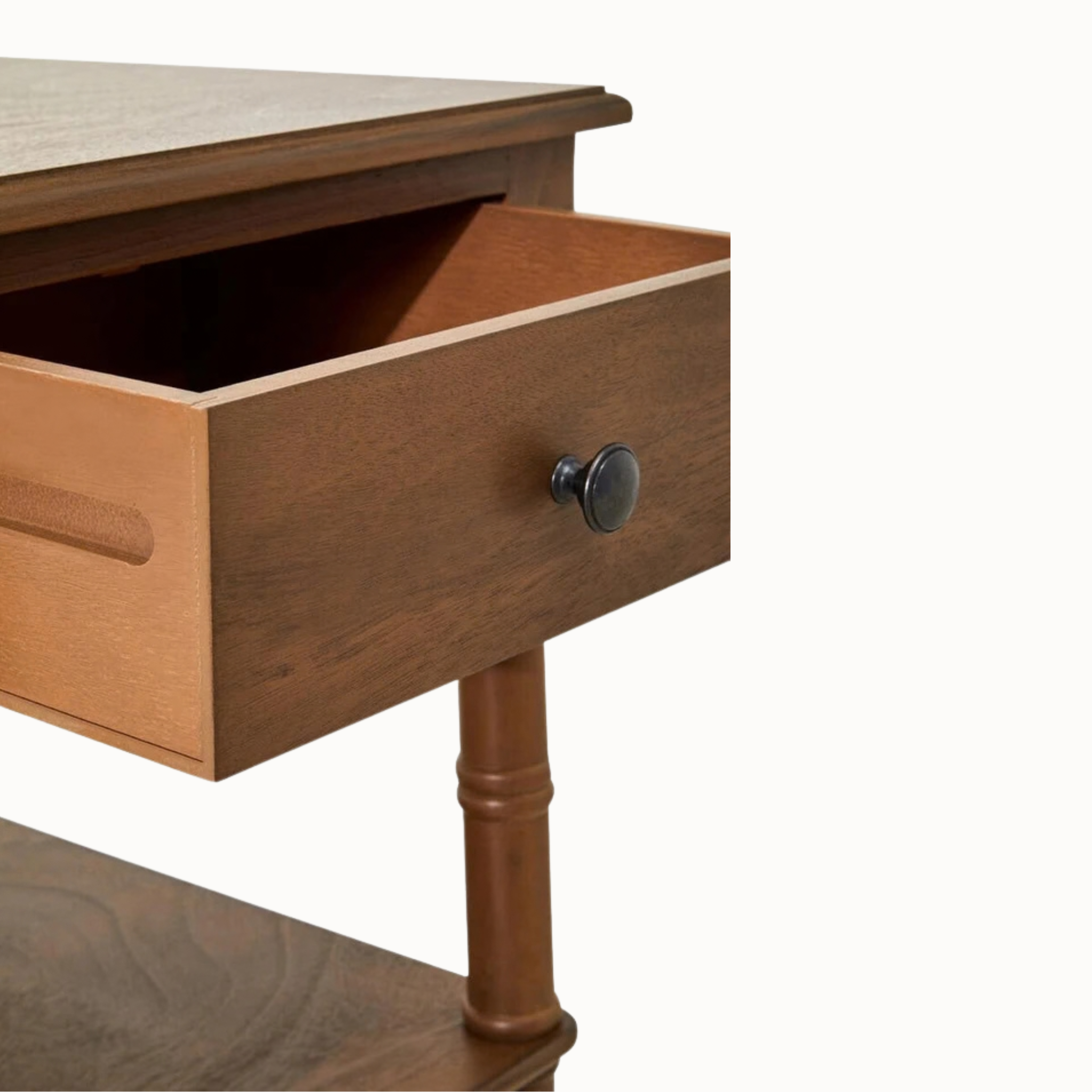 Close-up of Aveline brown wood writing desk's two open storage shelves, natural wood grain and turned legs on white.