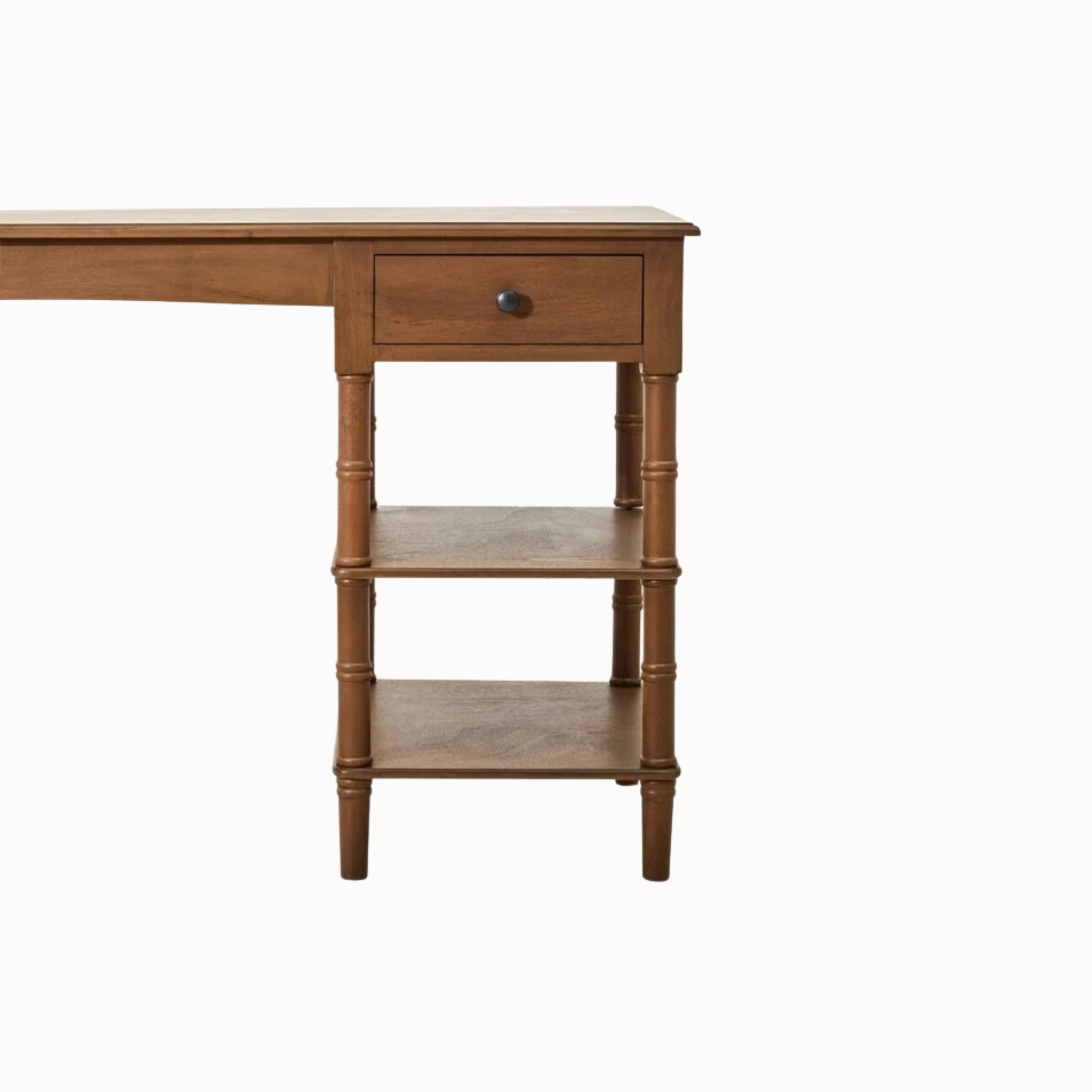 Aveline brown wood writing desk close-up showing closed drawer with dark round knob, turned legs and shelf on white.