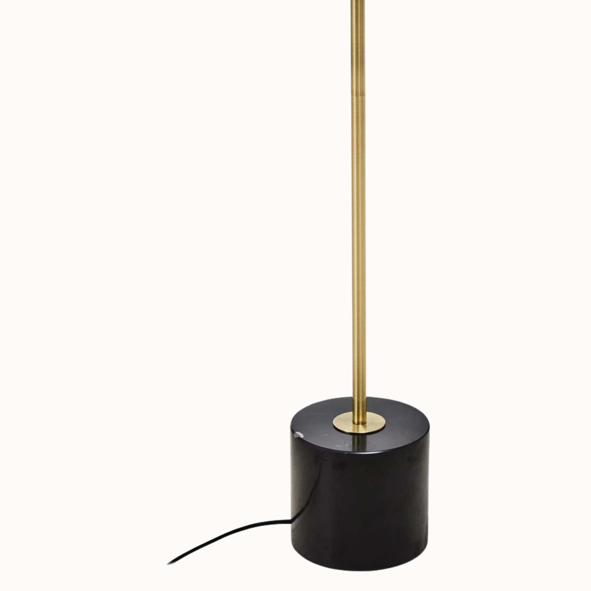 Close-up of Benoît black marble base and brushed brass stem against a plain white background.