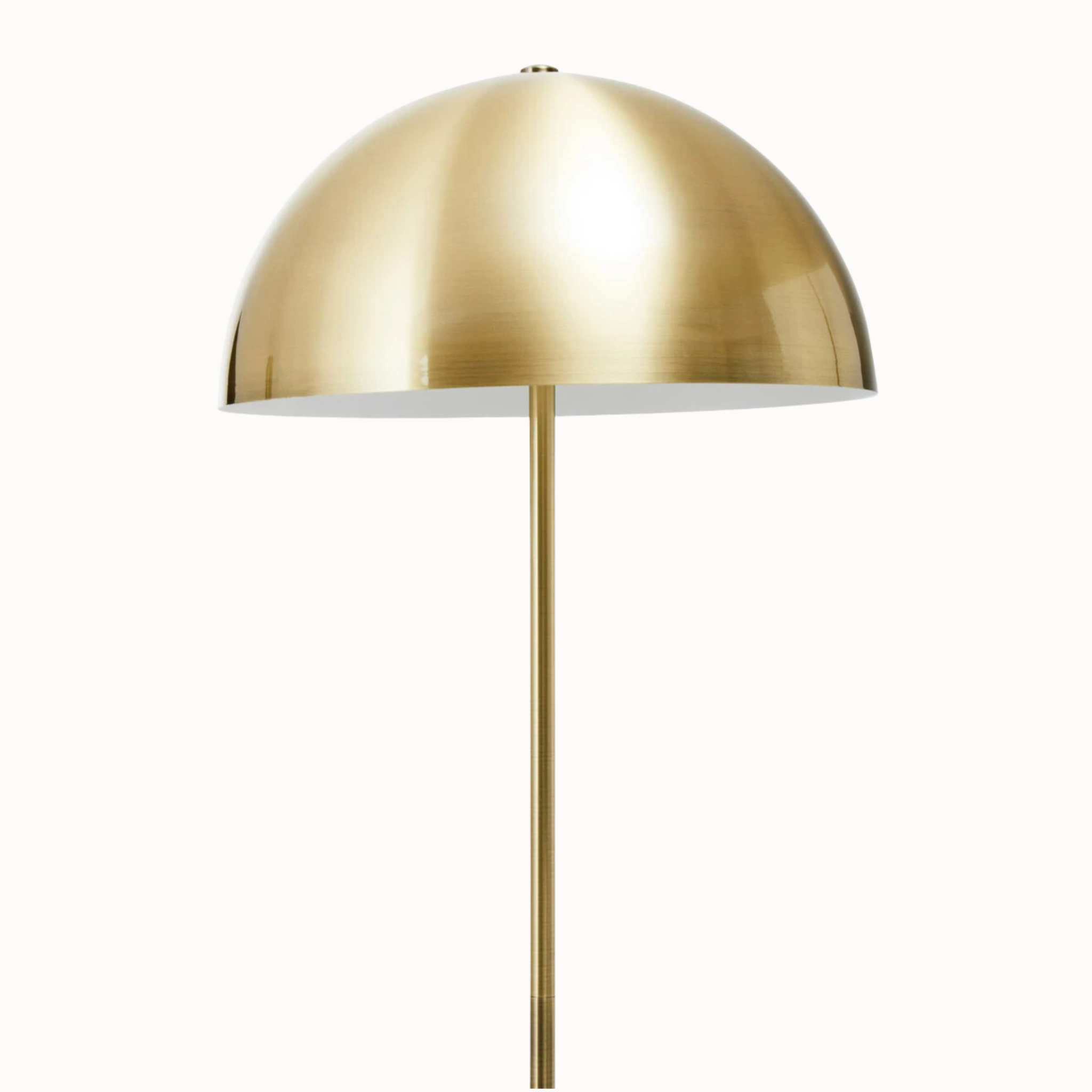 Close-up of Benoît brushed brass dome shade and slim stem against a plain white background.