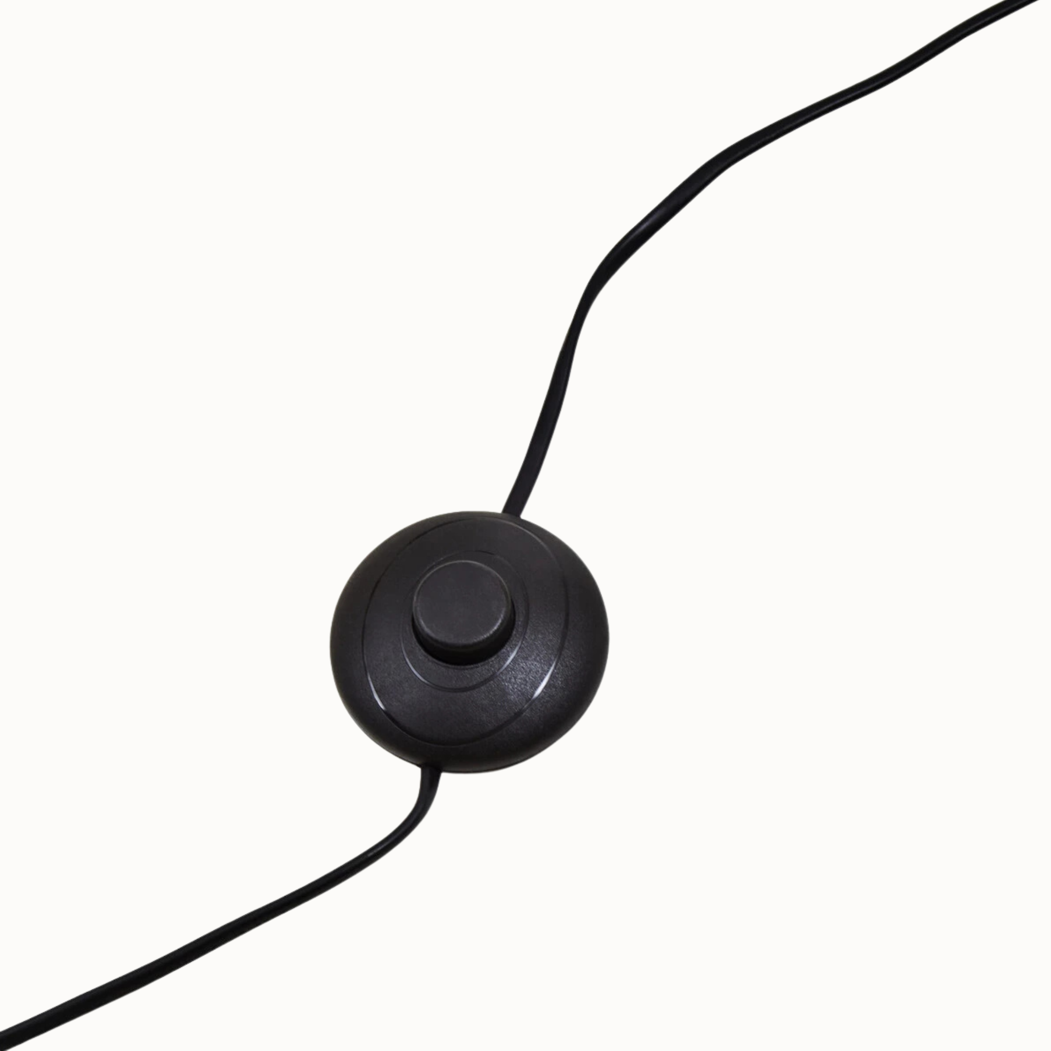 Close-up of Benoît floor lamp black foot switch and cable on a plain white background.