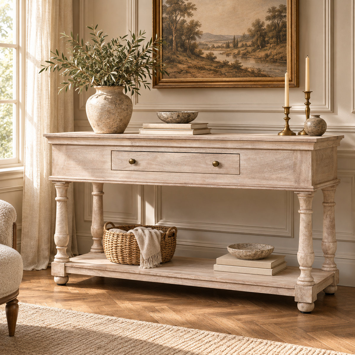 Camille acacia wood console table with drawer and lower shelf behind a cream sofa in a warm French living room