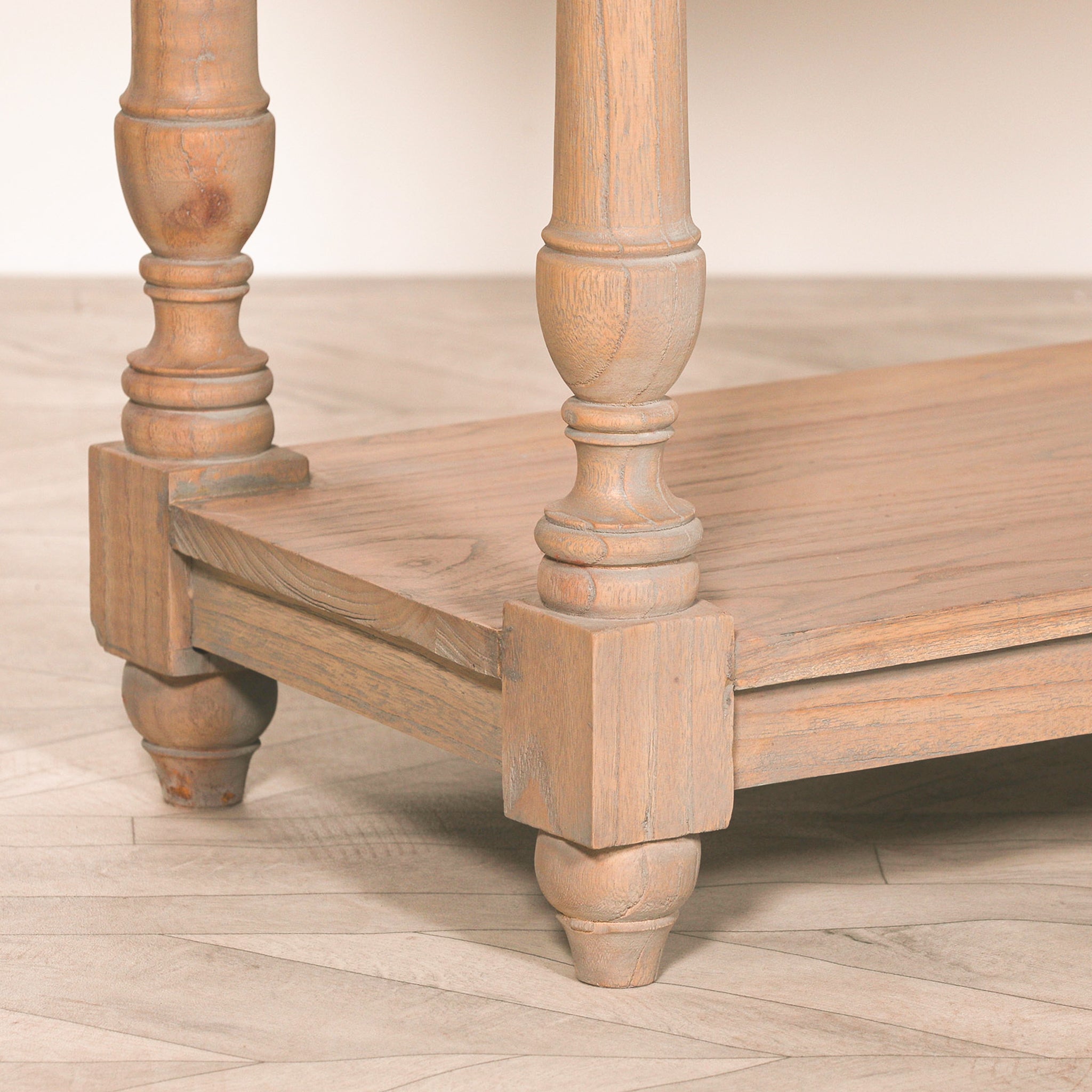 Detailed close-up of the Camille Breakfront white cedar wood console table highlighting the turned solid wood legs, lower storage shelf, rustic finish and traditional handcrafted detailing.