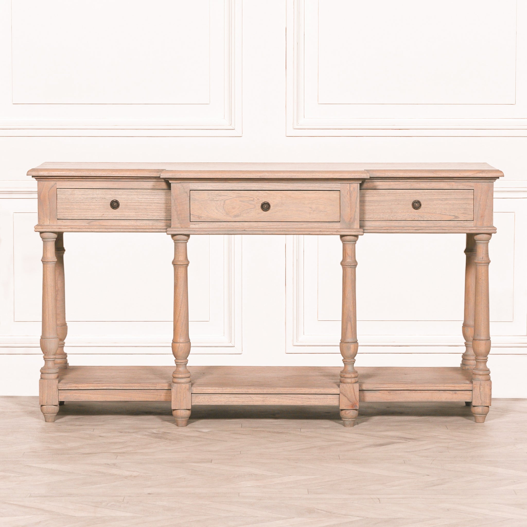 Straight-on view of the Camille Breakfront white cedar wood console table featuring three spacious drawers, traditional turned legs, rustic wood finish and generous lower display shelf for hallway storage.