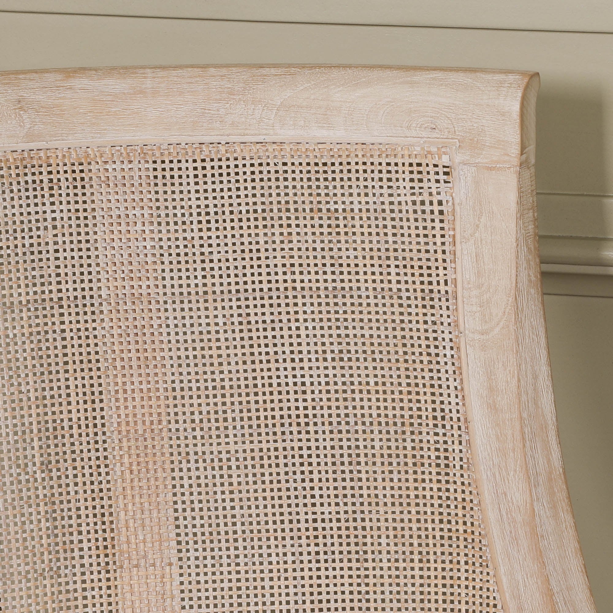 Detailed close-up of the Camille Cane Back Dining Chair showcasing the handwoven natural cane backrest and washed birch wood frame, highlighting the craftsmanship and texture of this French country dining chair.