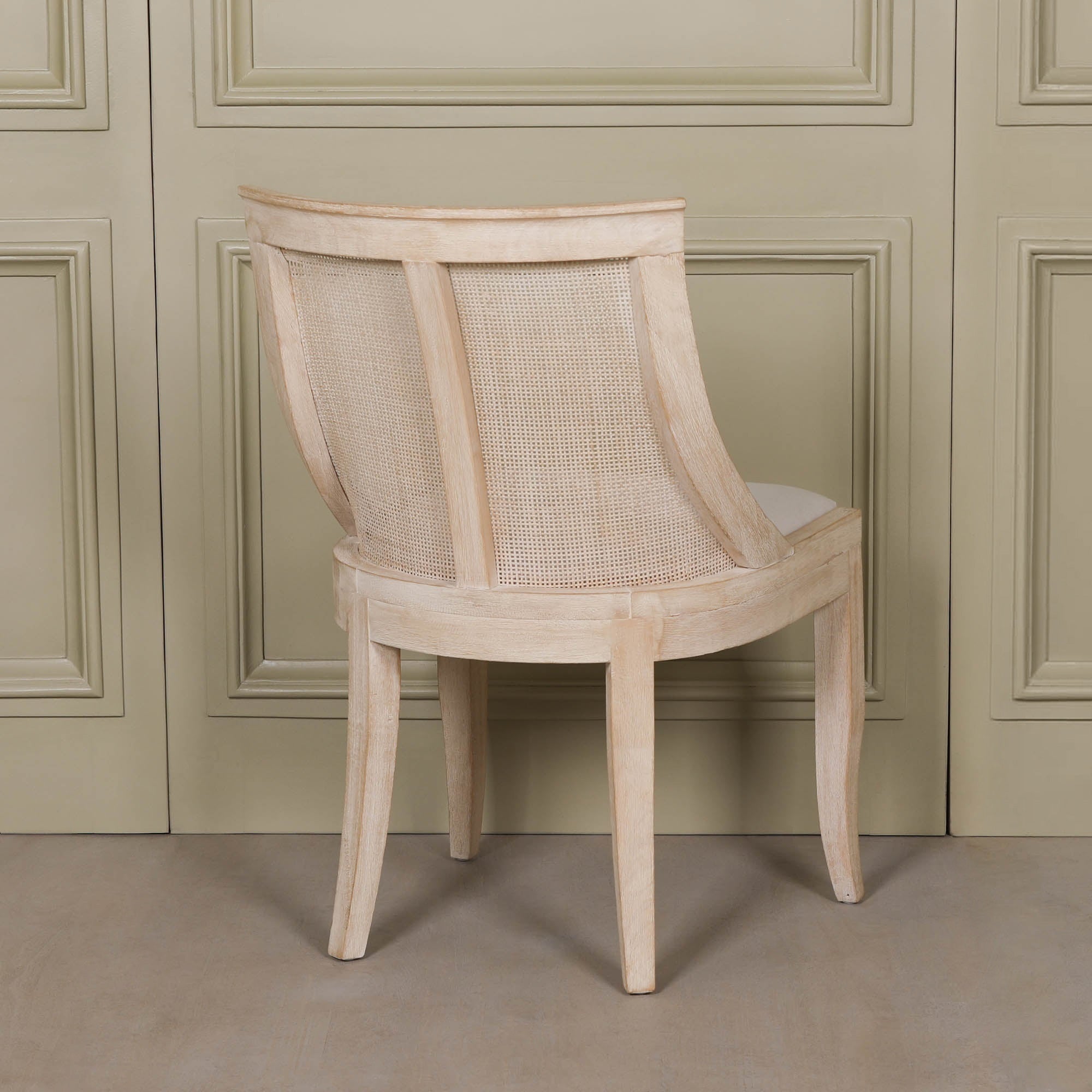 Rear view of the Camille Cane Back Dining Chair showcasing the beautifully framed natural cane backrest and washed birch wood construction, designed for elegant French-inspired dining spaces.