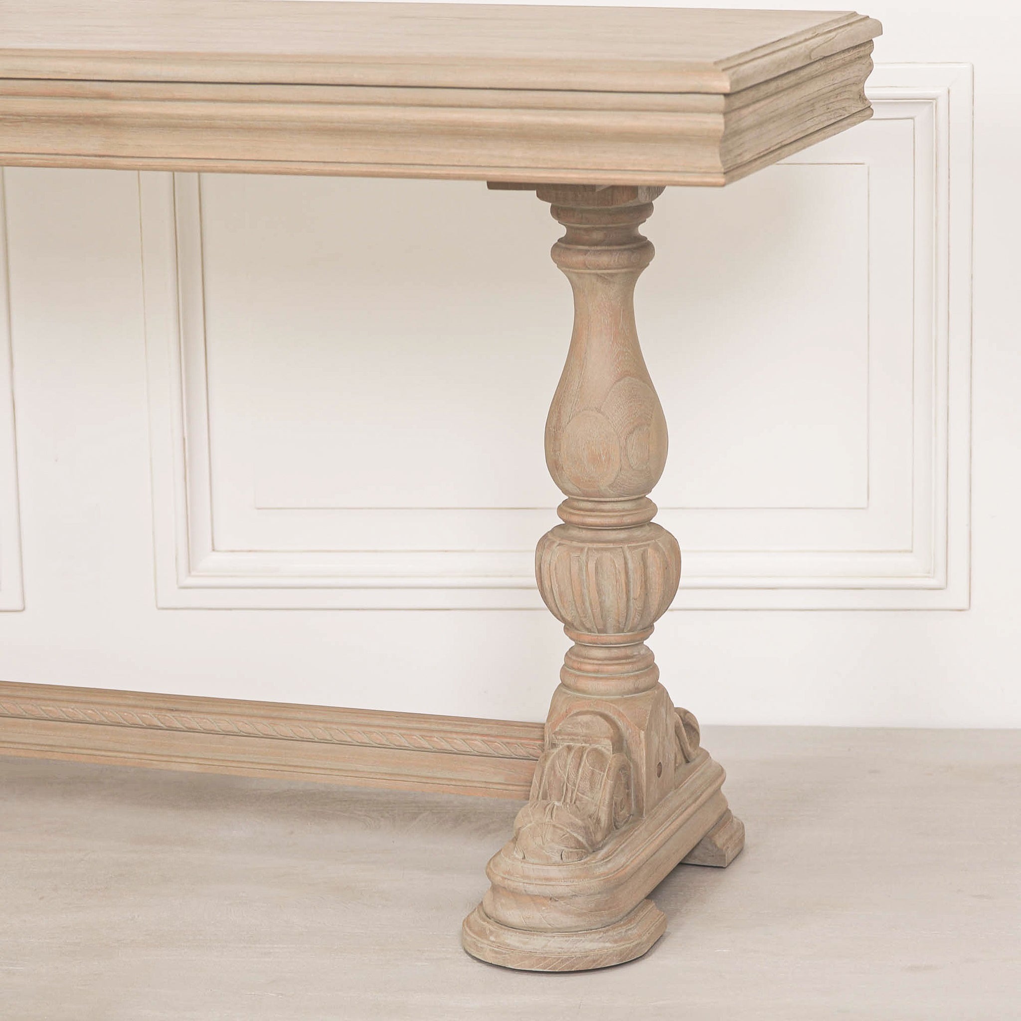 Detailed view of the carved pedestal leg, decorative plinth base and stretcher support on the Camille Carved White Cedar Wood Console Table with Drawer, emphasising its artisan craftsmanship and rustic French country styling.