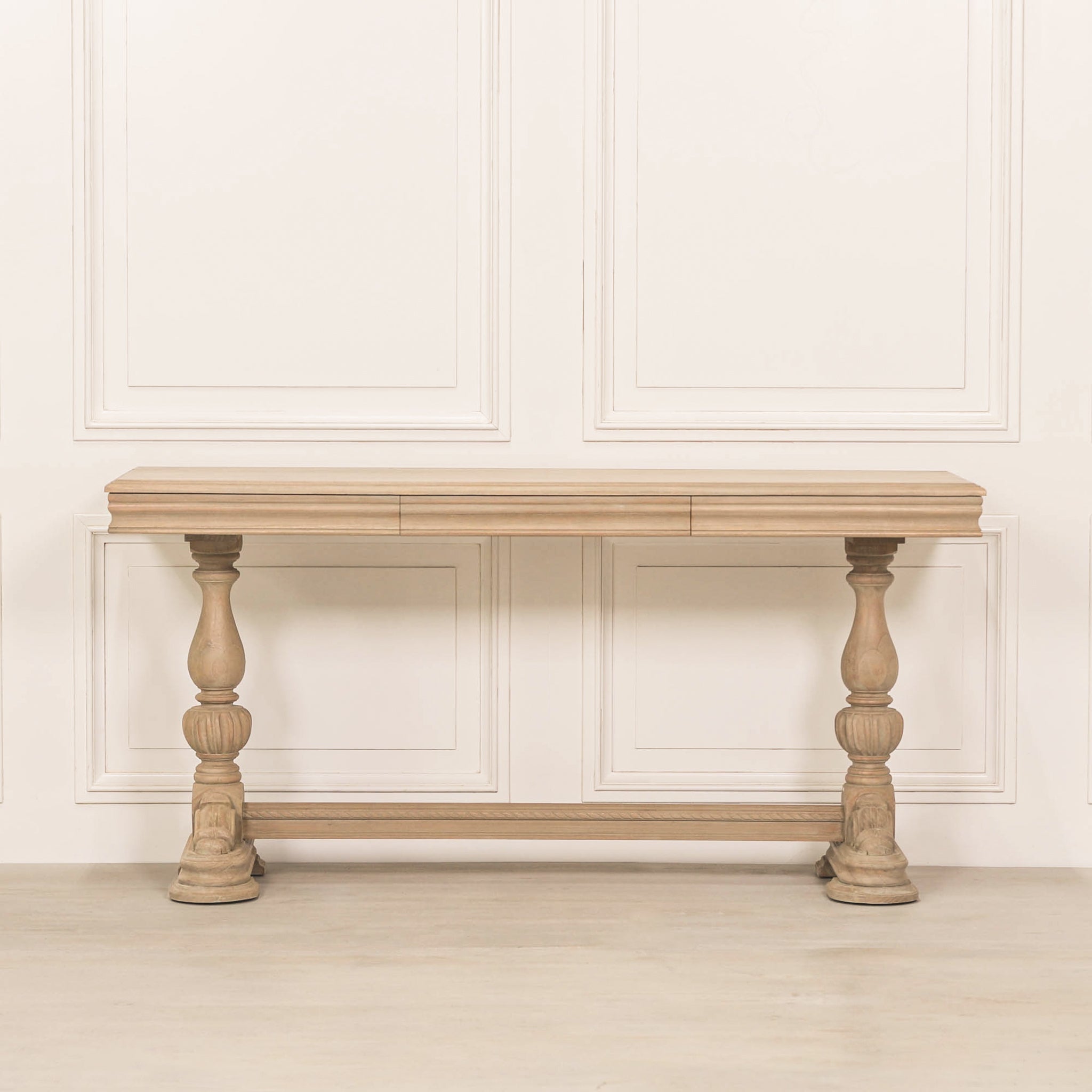 Full front view of the Camille Carved White Cedar Wood Console Table with Drawer featuring a rustic white cedar wood finish, decorative carved pedestal legs, stretcher support and timeless French country craftsmanship.