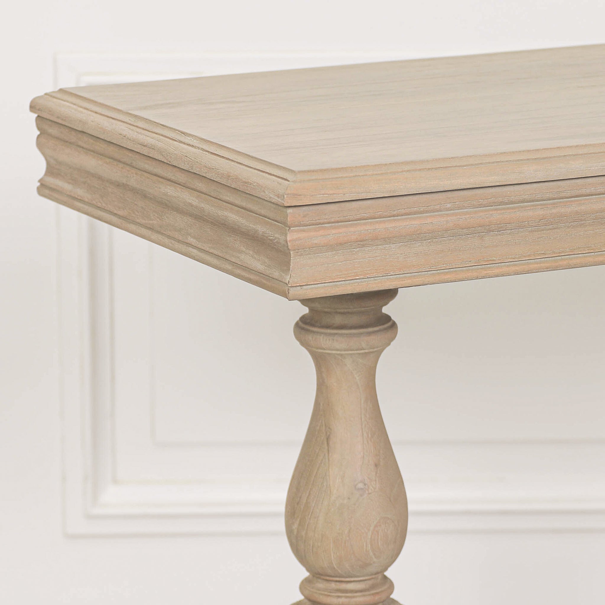 Close-up of the tabletop edge and turned pedestal leg on the Camille Carved White Cedar Wood Console Table with Drawer, showcasing the natural white cedar wood grain, moulded edging and elegant rustic finish.
