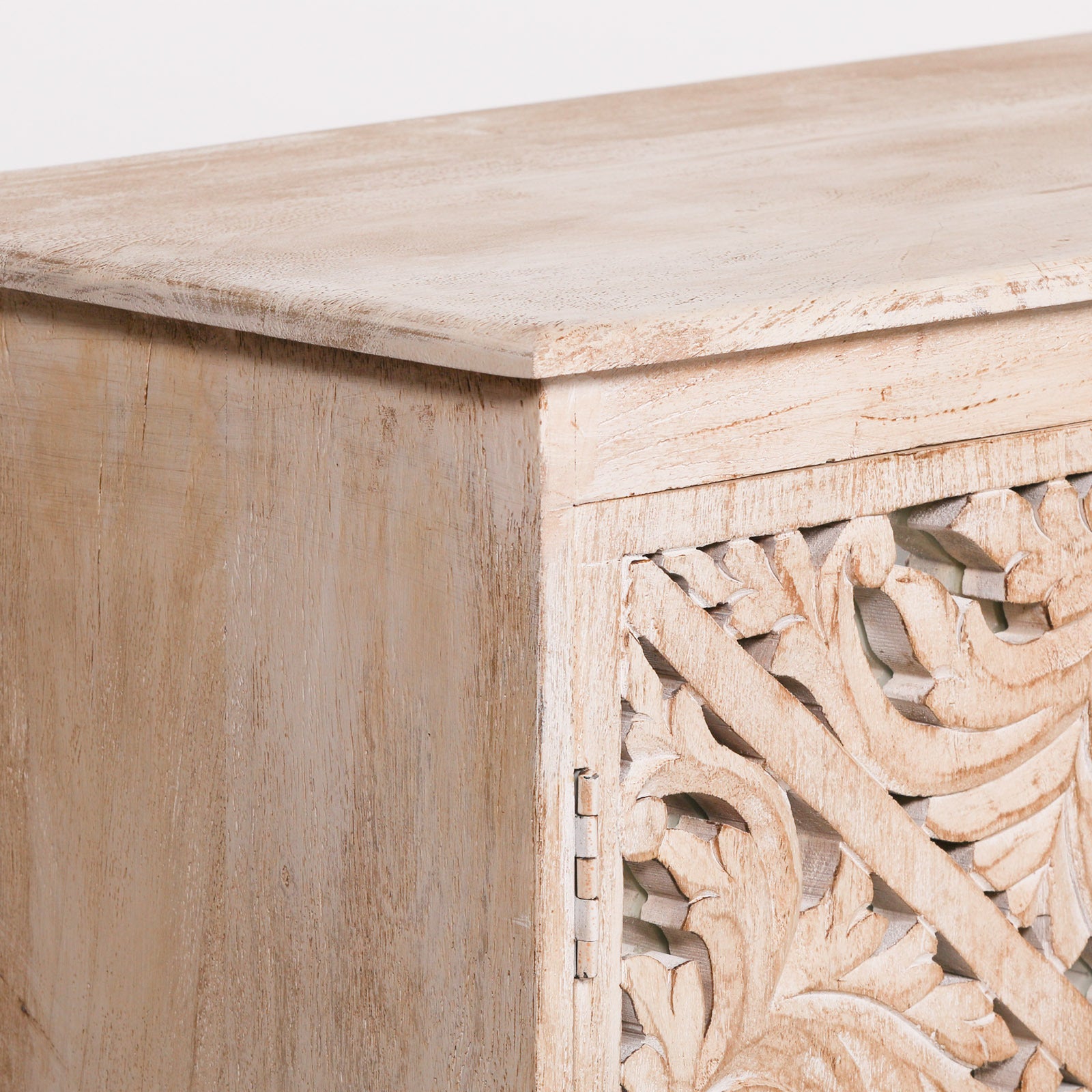 Close-up of the Camille Four Door Carved Mirrored Sideboard highlighting the bleached mango wood cabinet frame, hand carved mirrored panel and premium artisan furniture craftsmanship.