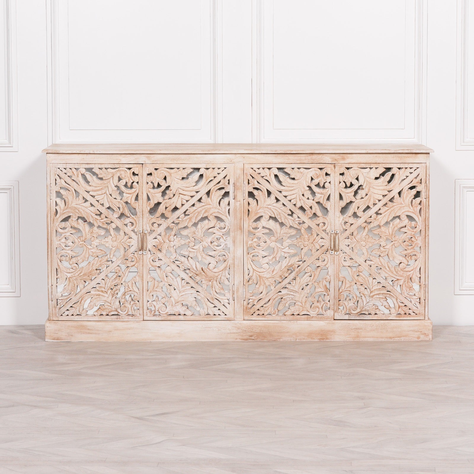 Front elevation of the Camille Four Door Carved Mirrored Sideboard featuring four intricately carved mirrored doors, bleached mango wood construction and generous concealed storage space.