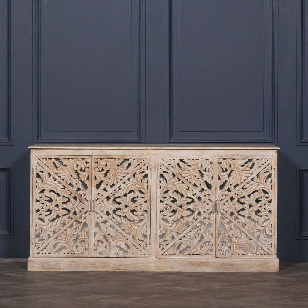 Front view of the Camille Four Door Carved Mirrored Sideboard in bleached mango wood featuring intricate hand carved mirrored doors, generous concealed storage and timeless artisan craftsmanship.
