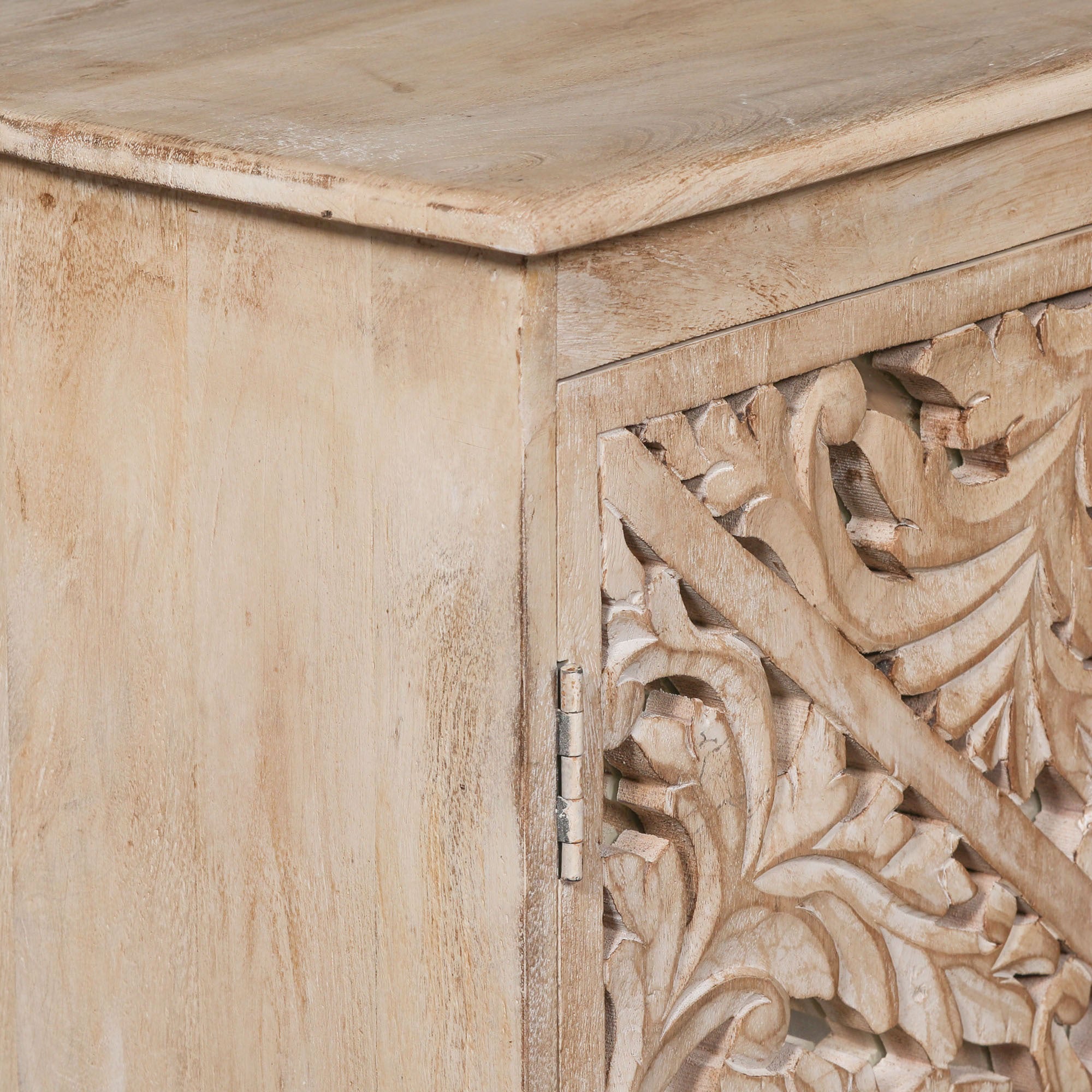 Detailed view of the Camille Four Door Carved Mirrored Sideboard showing the solid bleached mango wood top, handcrafted cabinet frame and beautifully carved mirrored door detailing.